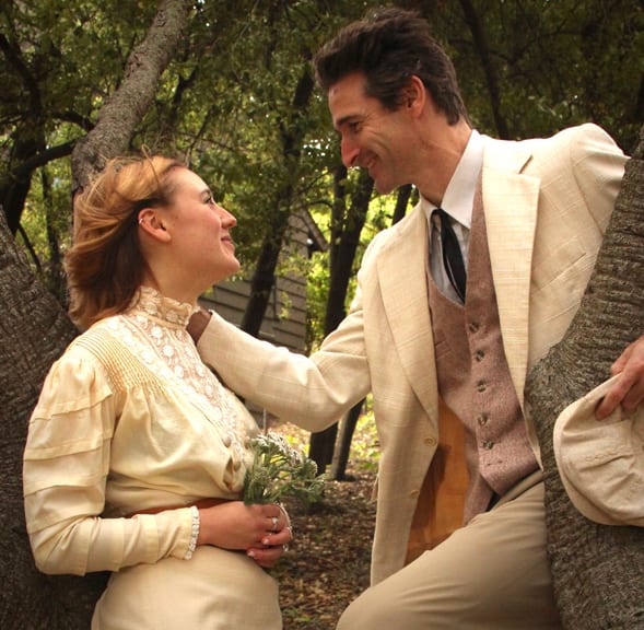 Lucy (Sophie Ruf) and George (Tyler Scott Null) gazing at one another with in a park setting.