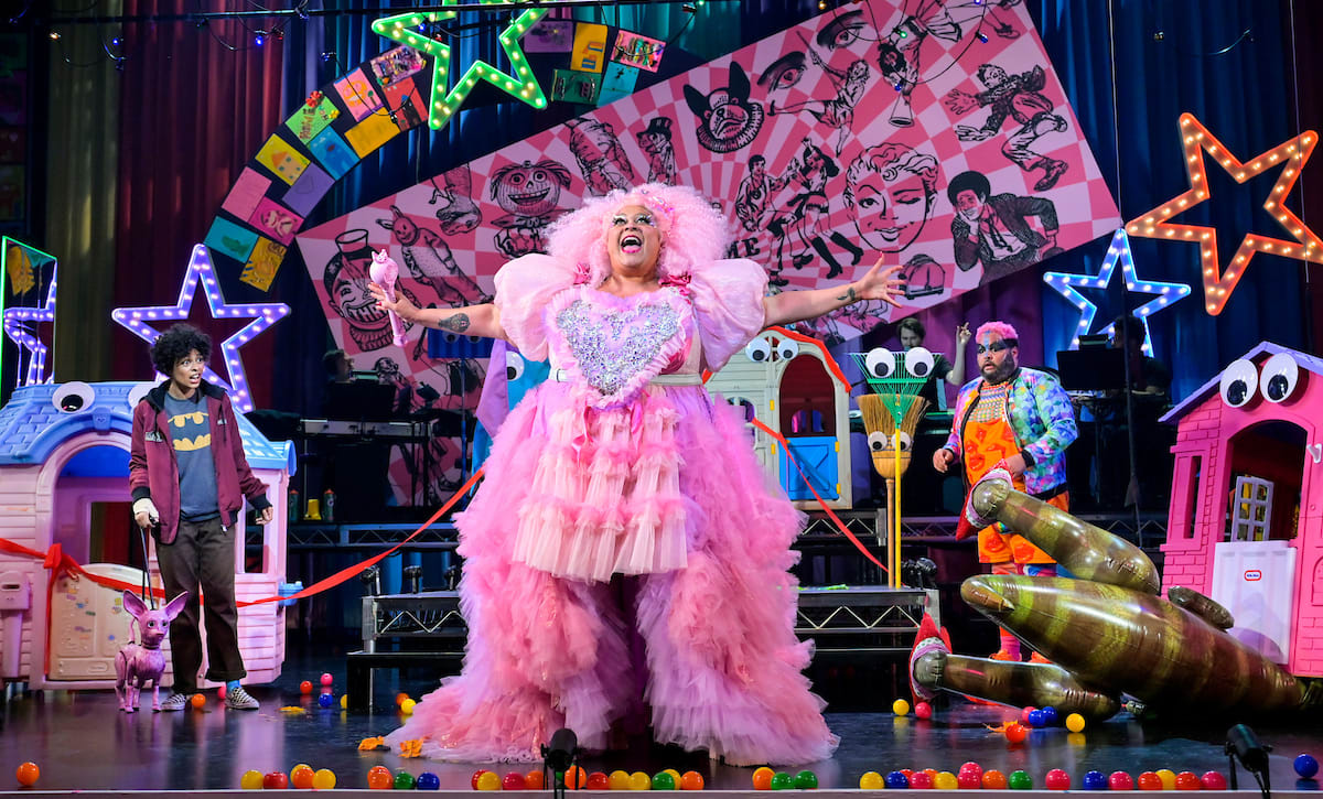 A bright, vibrant Munchkinland featuring Glinda the Good Witch