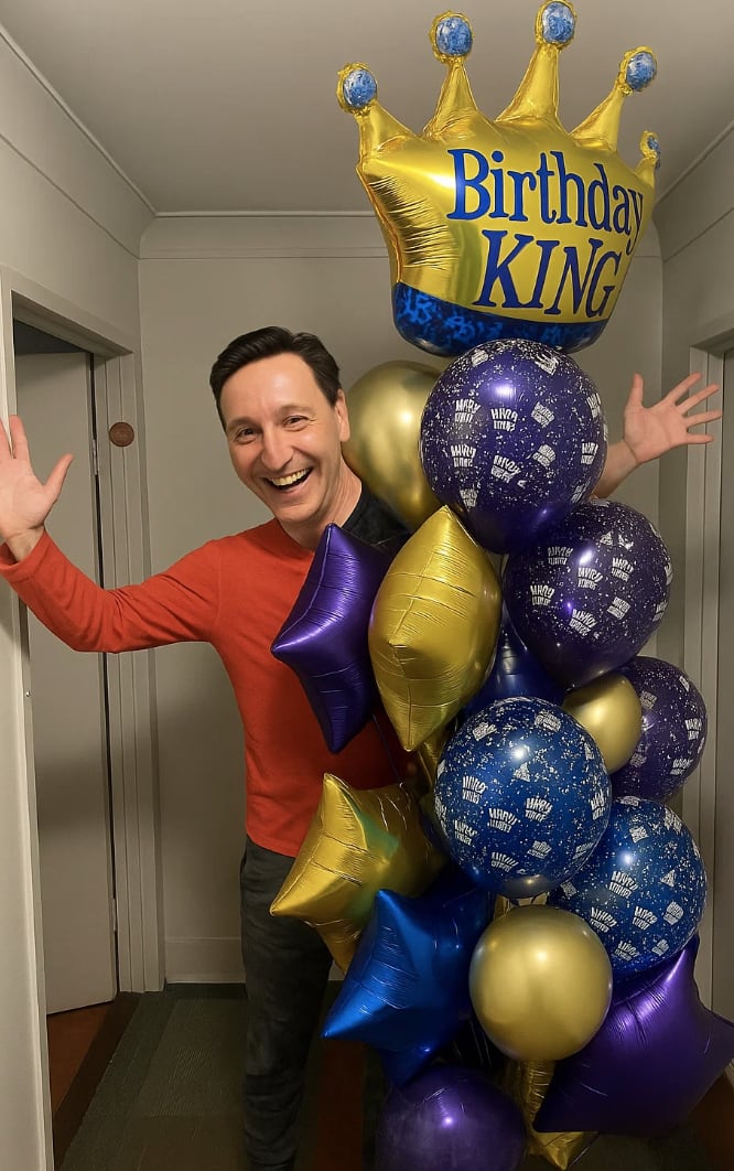 Man celebrating with a Birthday King balloon bouquet in Dallas.
