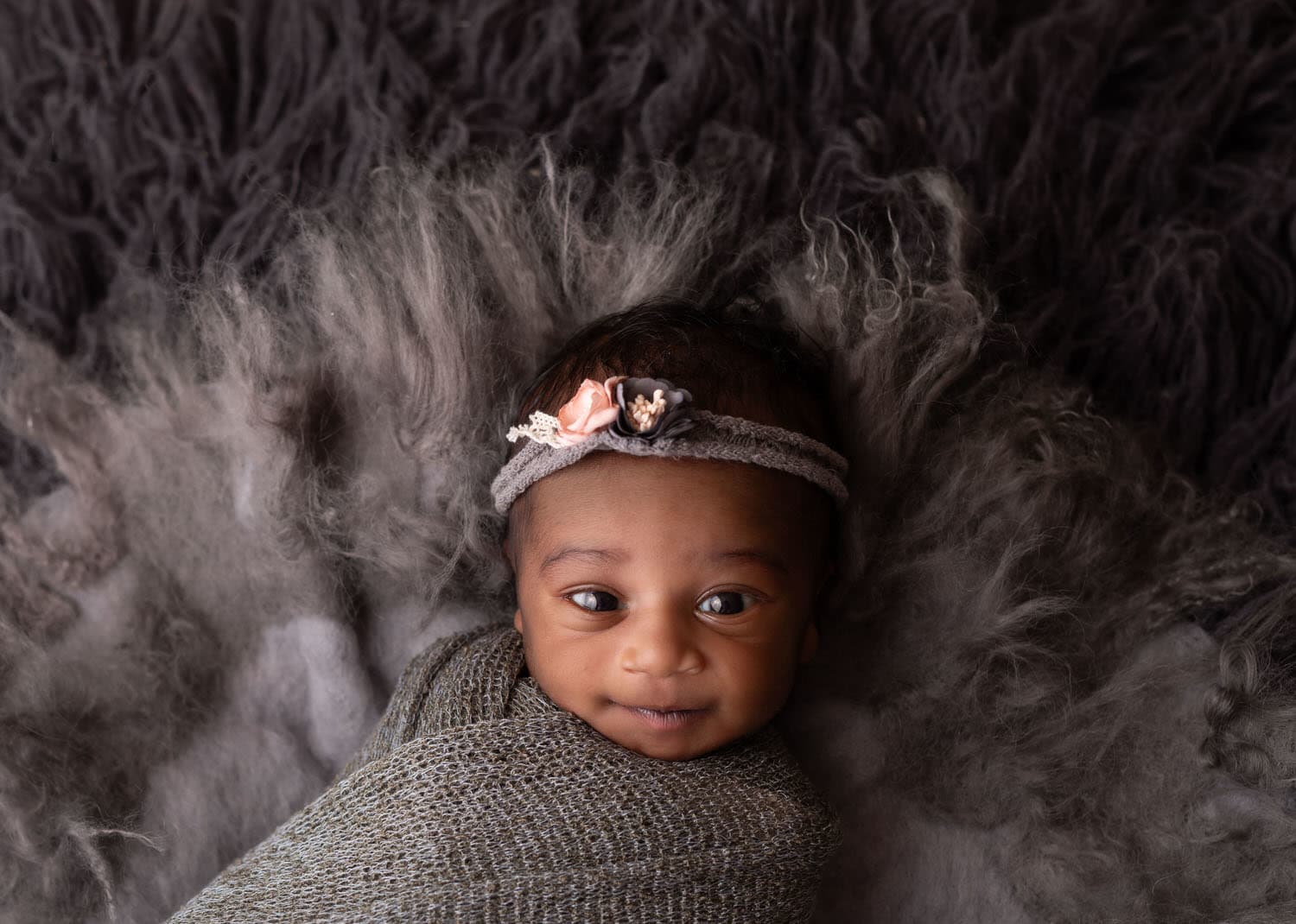 Newborn Girl Wrapped In Grey. Awake. Floral Headband