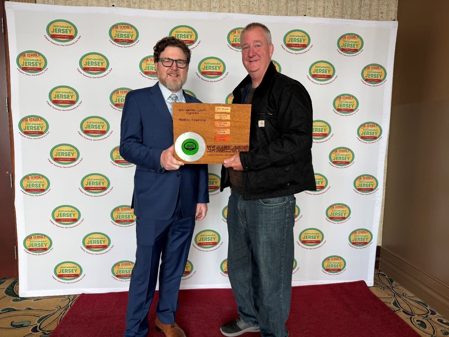 Bob King, Mayor and Environmental Commission Liaison, Raritan Township, right, accepts the updated plaque from Randall Solomo