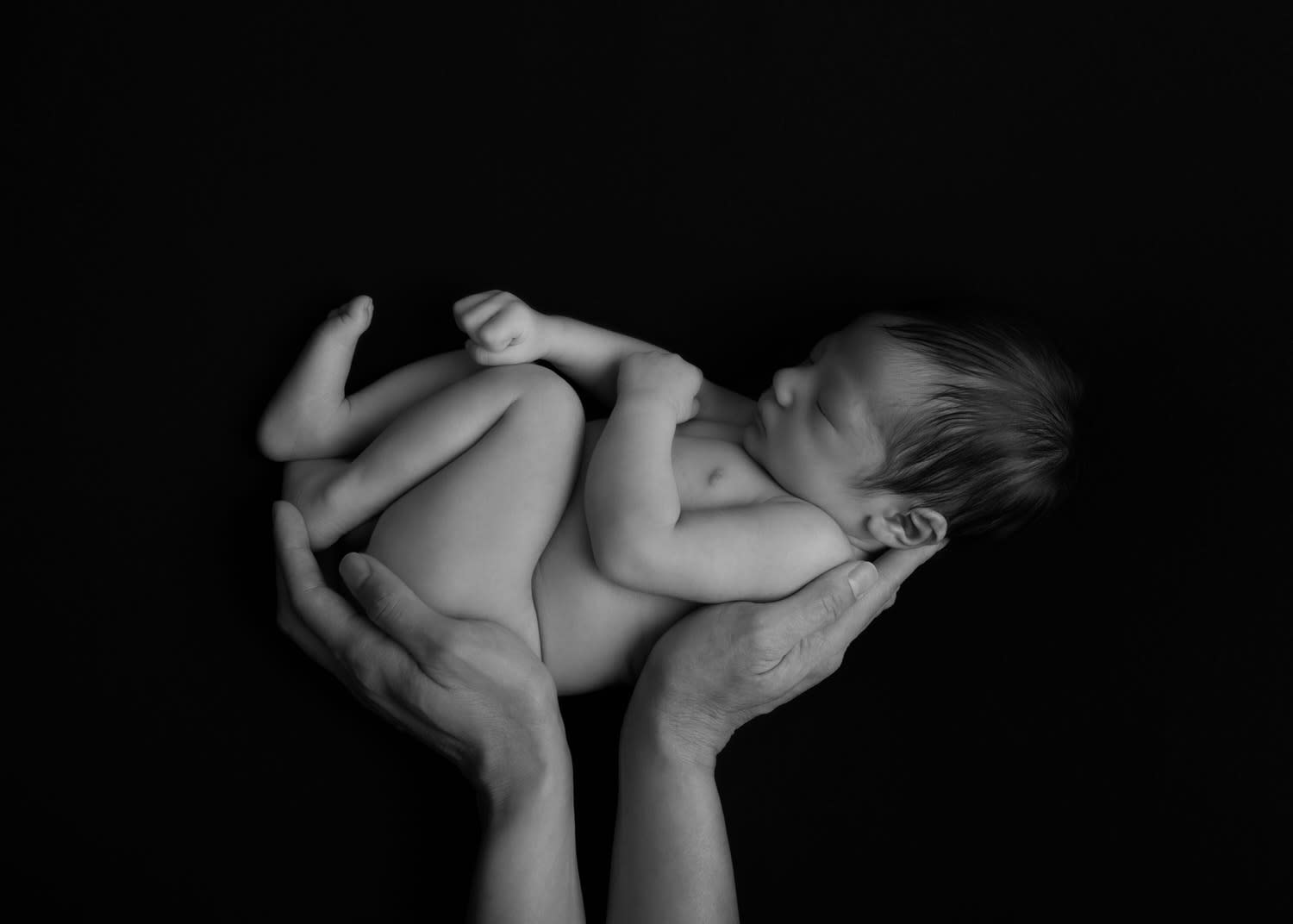 Black and White Photo of Newborn Boy, Naked, In Mom's hands