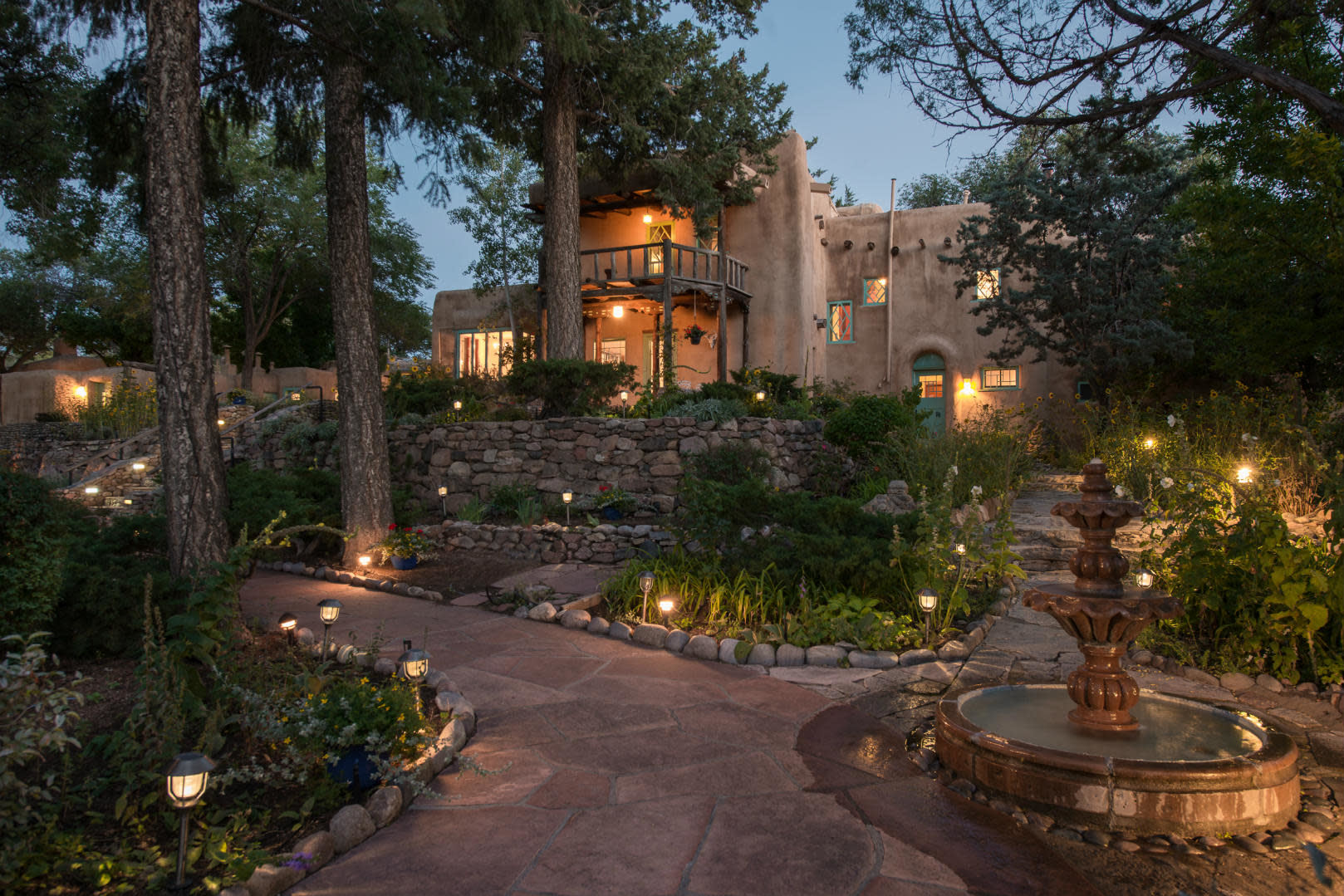 Fountain, garden, and Inn at twilight