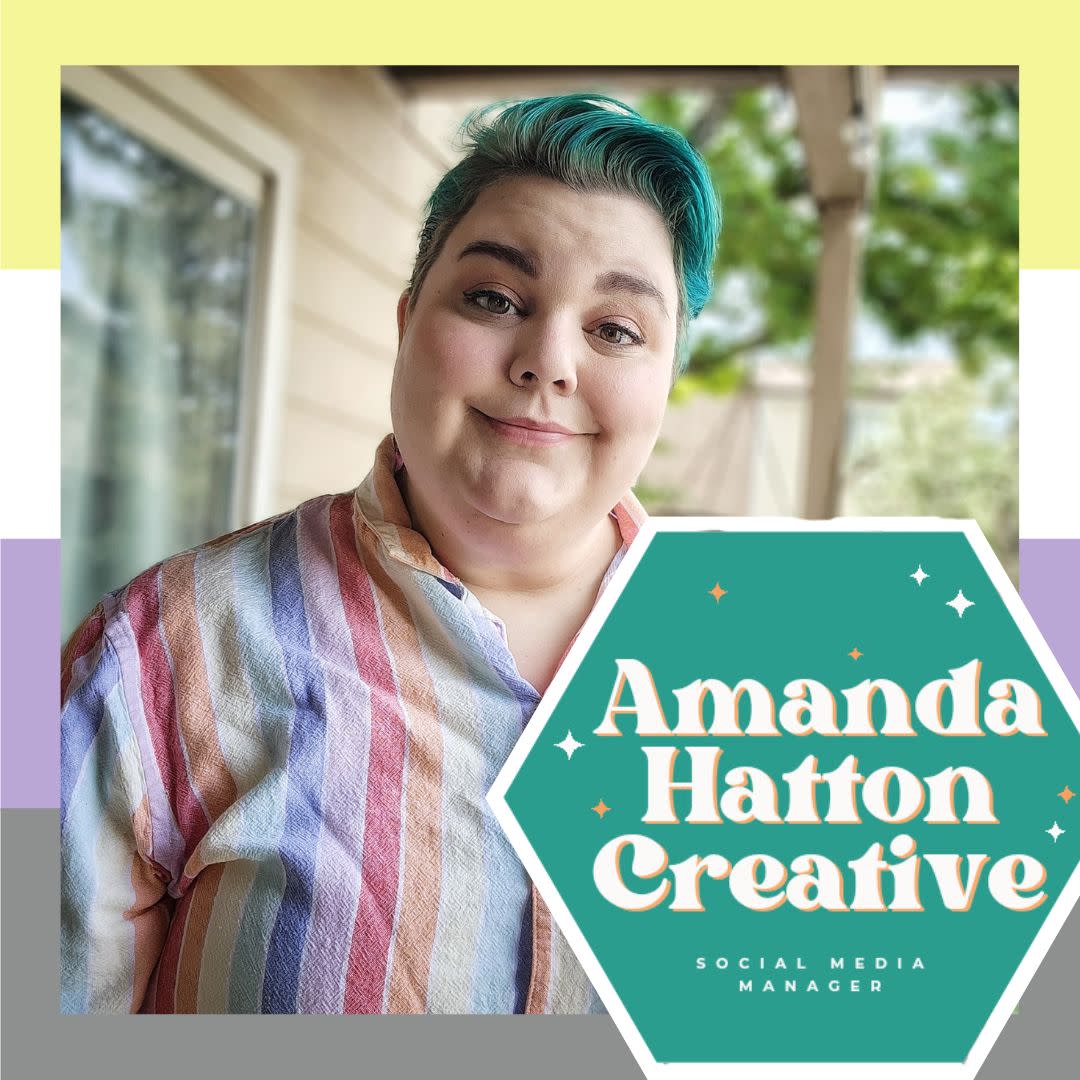 A picture of a caucasian nonbinary person with green hair wearing rainbow button down outside in front of the nonbinary flag