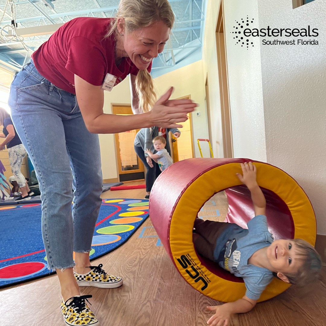therapist plays with child who is inside a circular mat