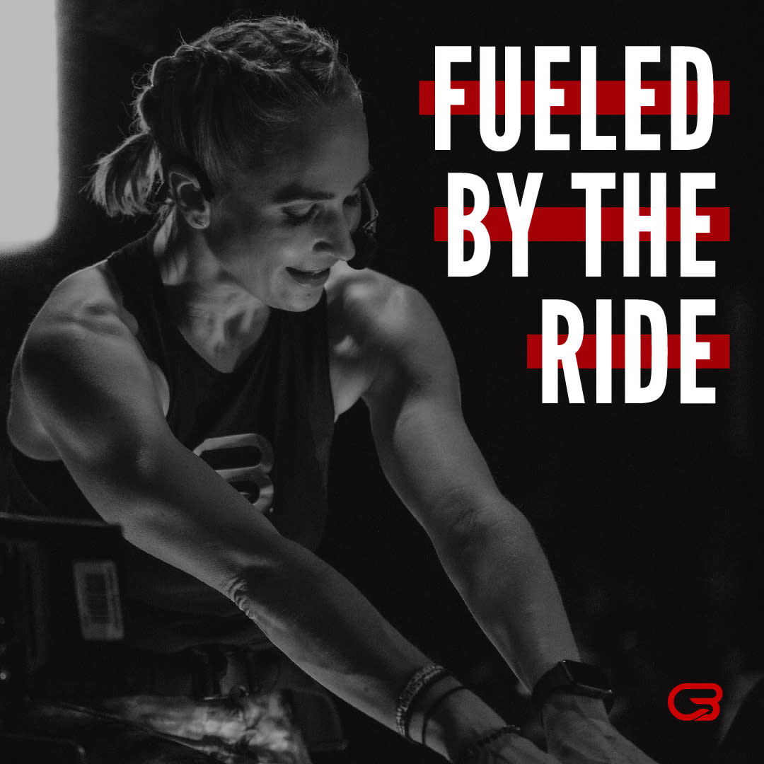 Picture of an indoor cycling instructor leading a ride with the text "Fueled by the ride"