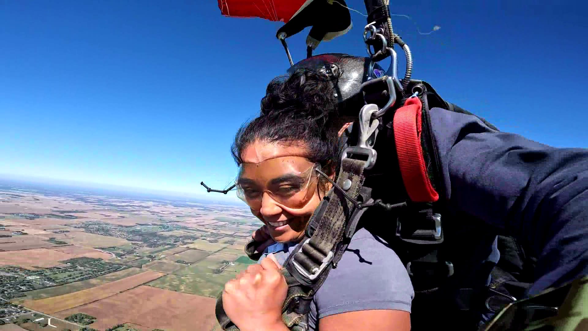 MSIG employee benefits agent, Shannon Anderegg, smiling as she glides in her parachute above Baldwin, Wisconsin.