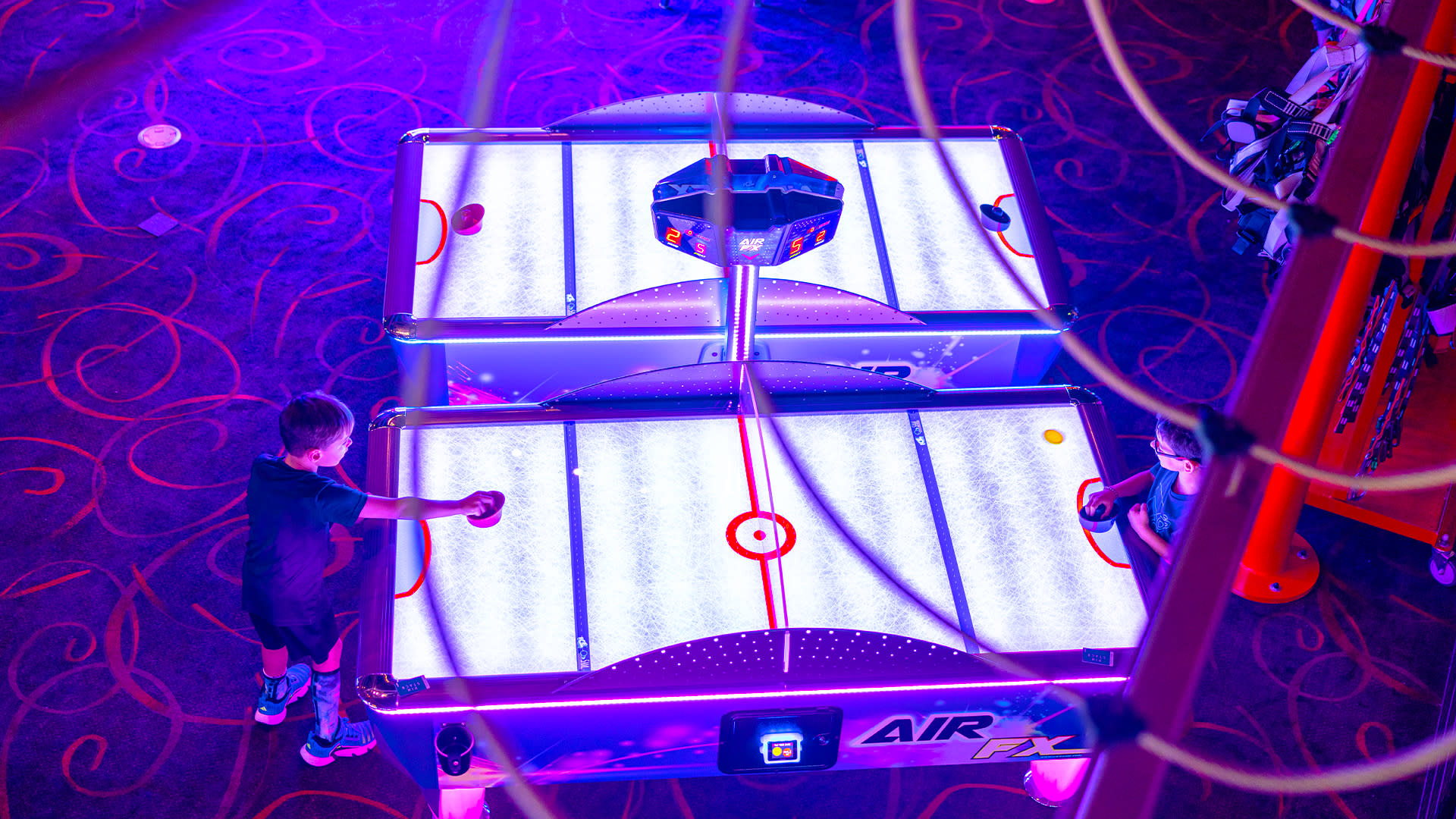 Image from the High Ropes Course looking down on air hockey game.