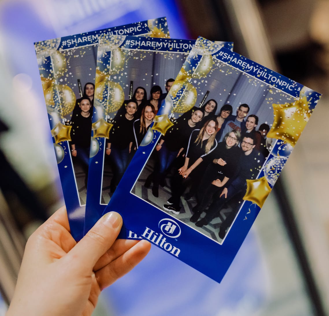 Guest holding branded photo booth prints from Gala Boss.