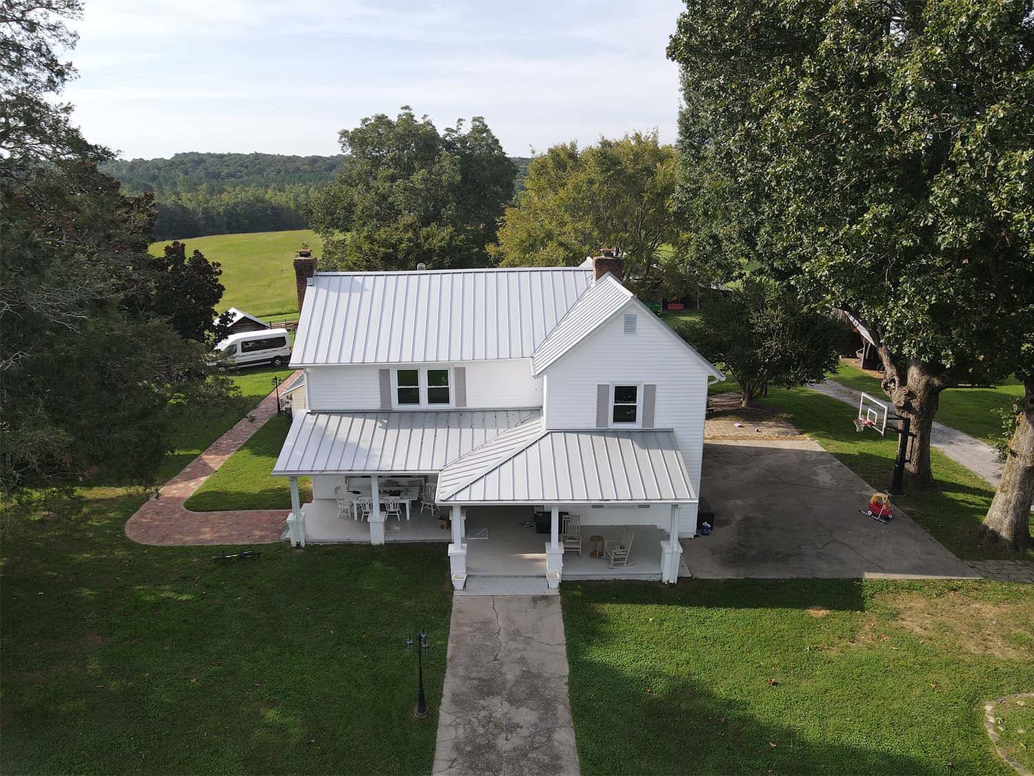 a white house with a grey metal roof