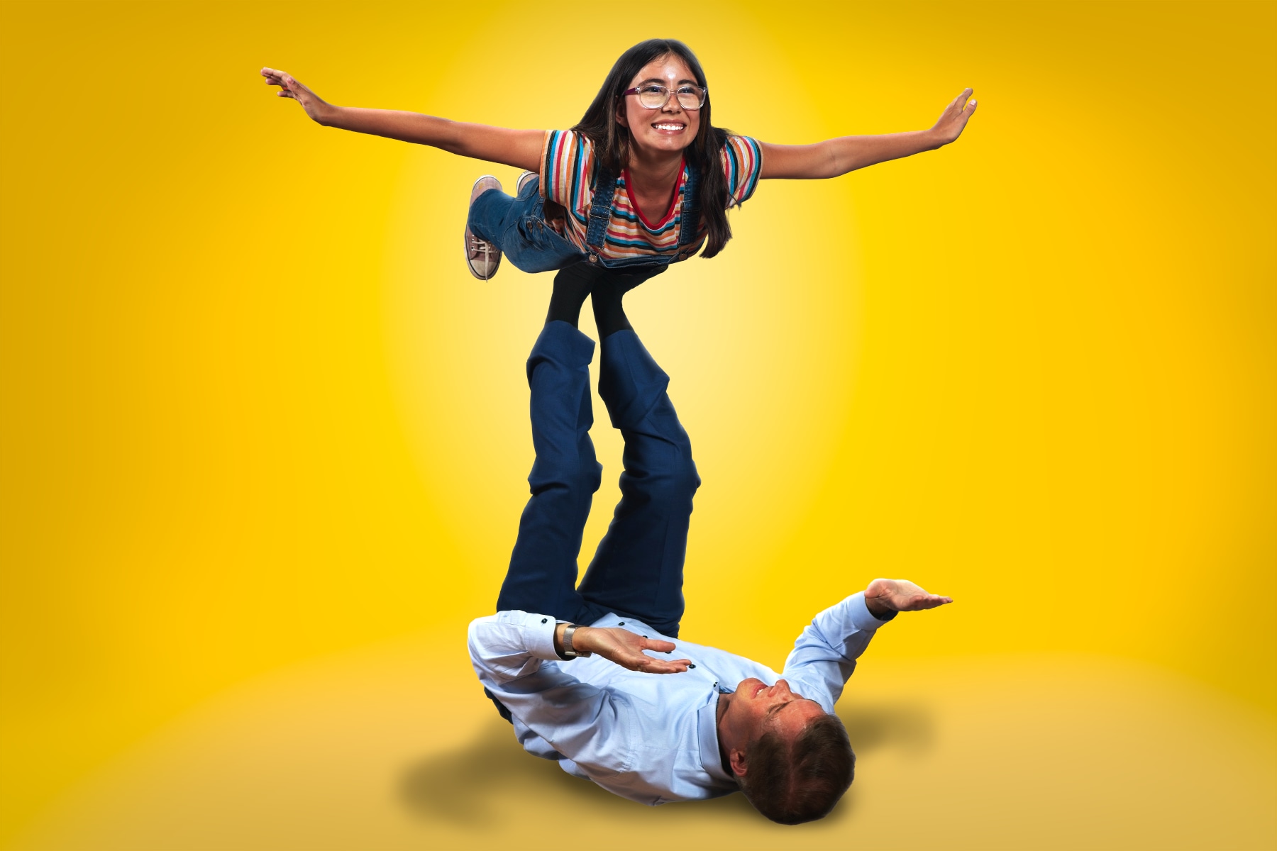 Young Allison plays "airplane" with her father