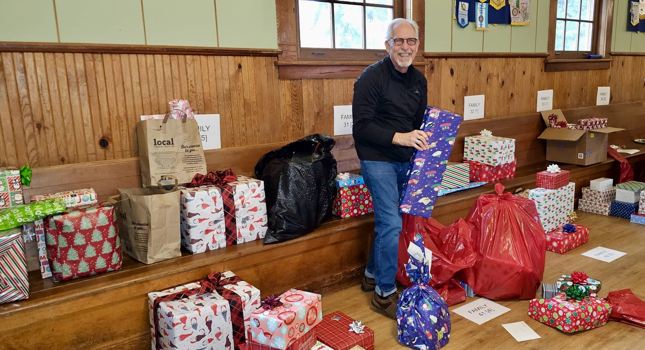 President Chuck Henschel of the White Salmon-Bingen Rotary Club helps sort for the Tree of Joy recipients