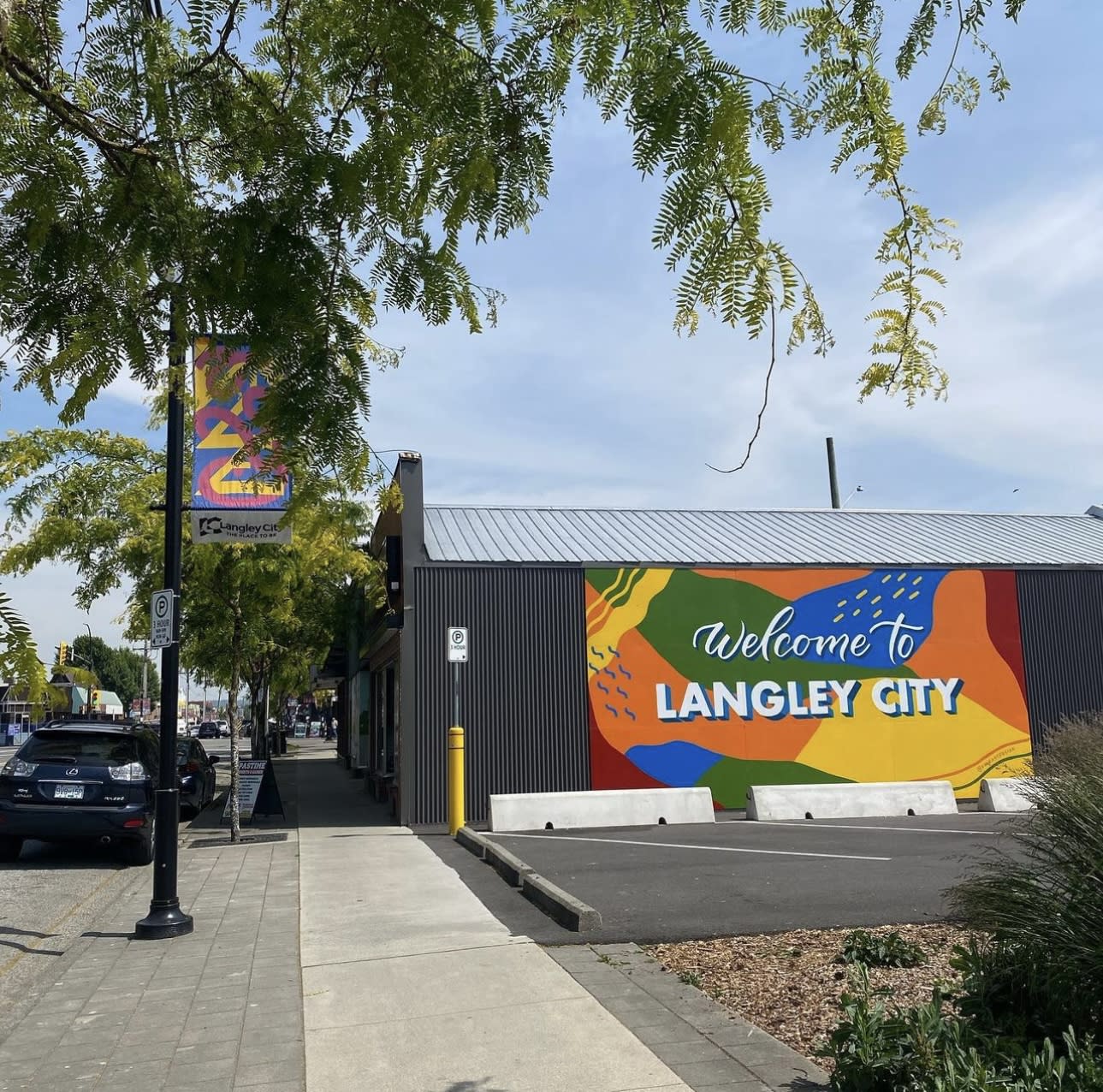 Bright and colourful mural with wording "Welcome to Langley city"