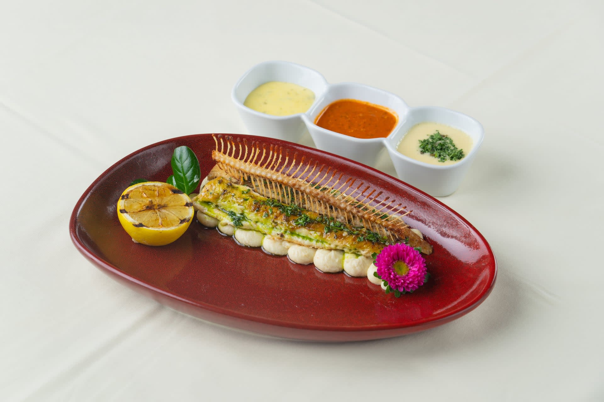 Dover sole meunière with piped potato purée, caper brown butter, and grilled lemon at René at Tlaquepaque.