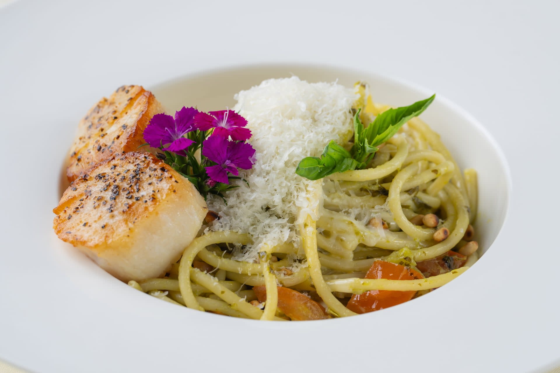 Bucatini pistou pasta topped with seared scallops, basil, pine nuts, and grated cheese at René at Tlaquepaque.