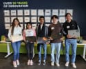 Orases presents laptops to 5 LYNX students, image of 5 students holding a laptop