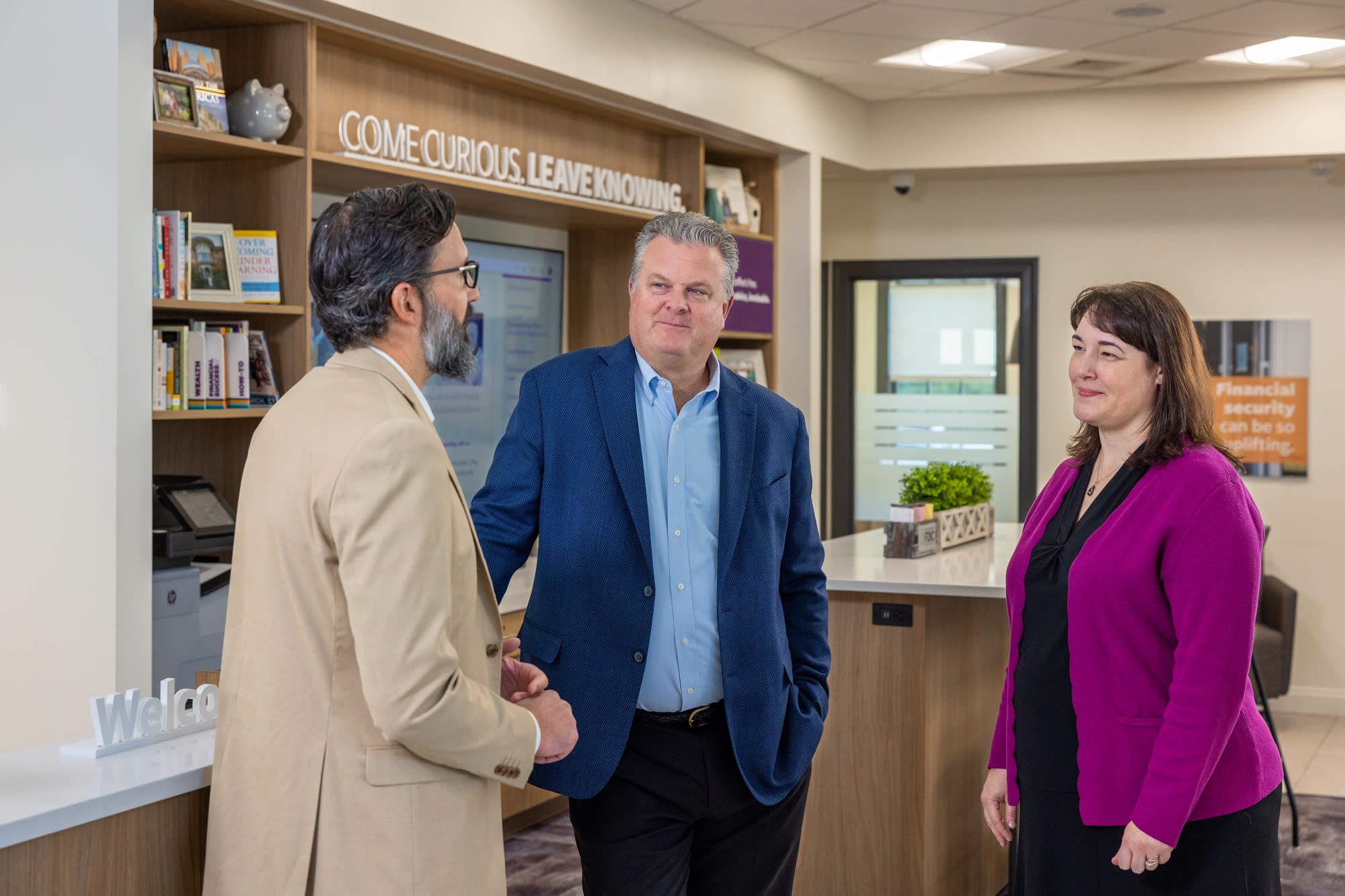 three people talking in a bank branch