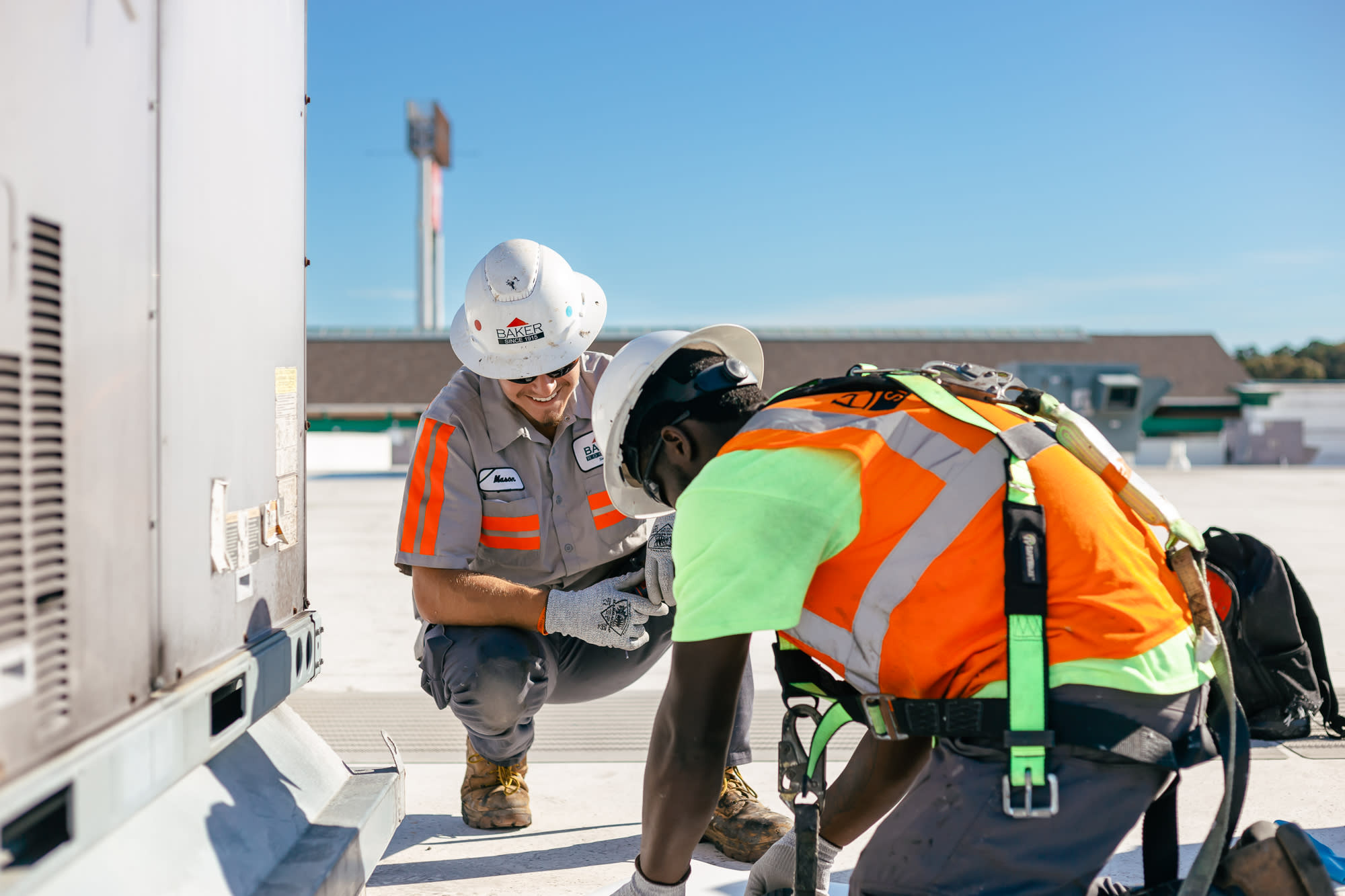 Two men repairing a roof leak