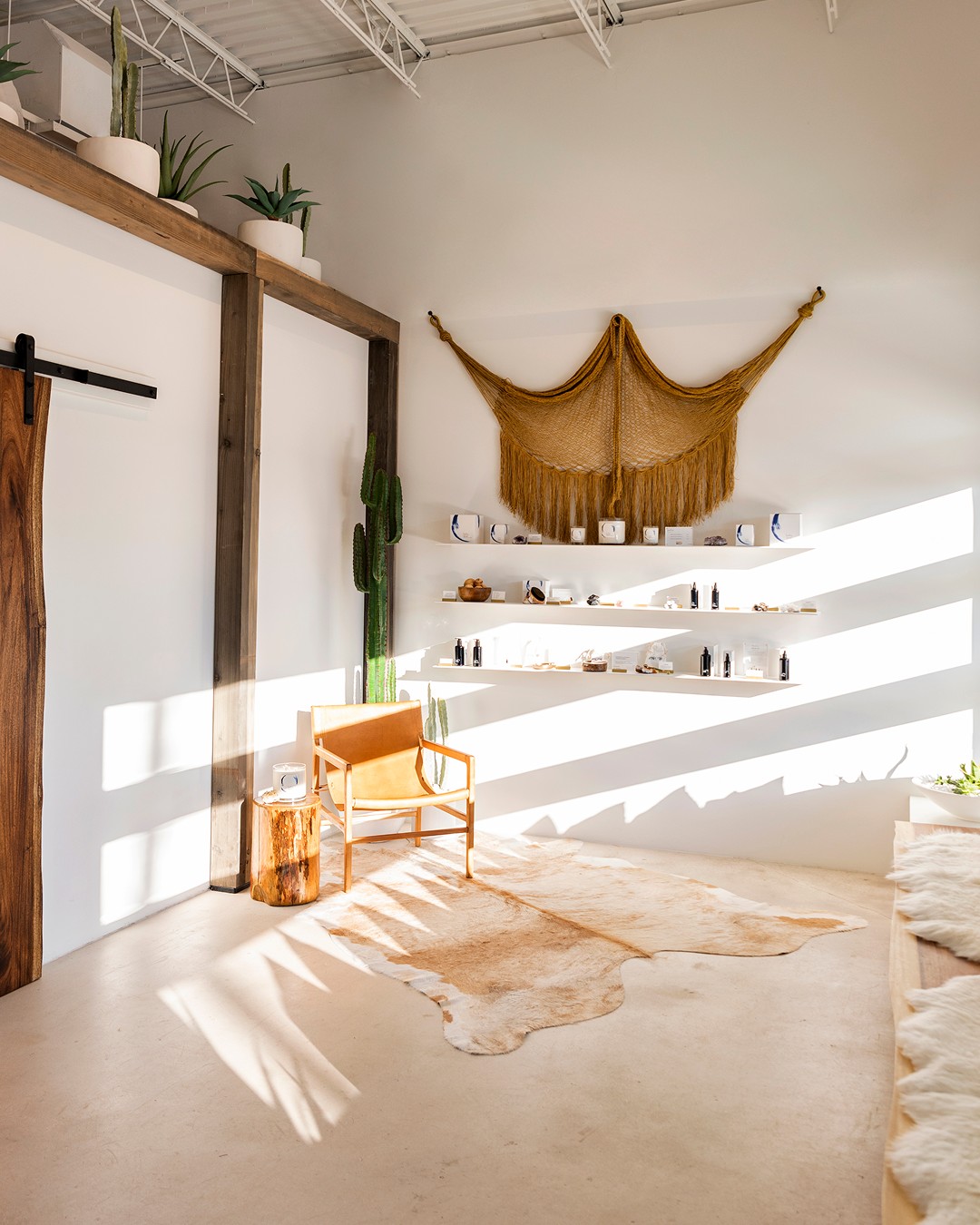 Modern massage boutique reception at The NOW Dallas with retail wellness products