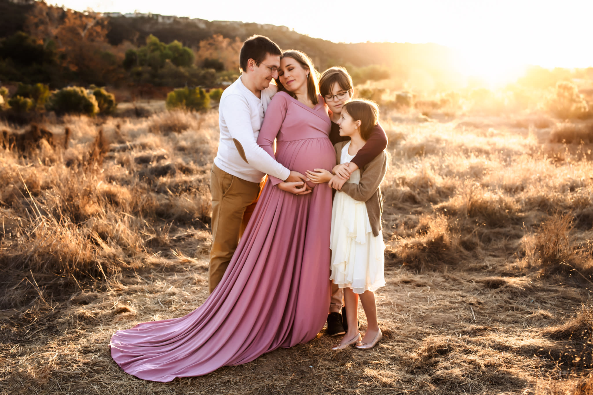 Maternity image with Mother, Father, Son, and Daughter in open field in San Diego