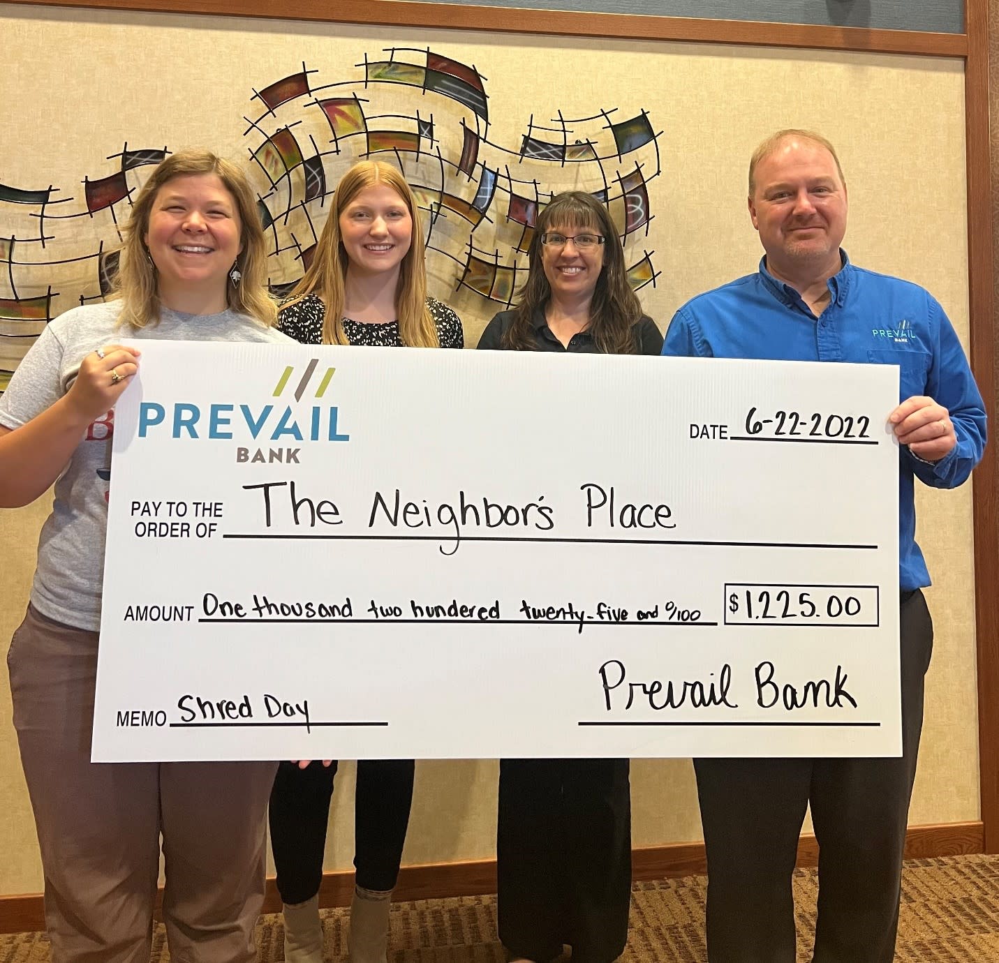 Prevail Bank presents $1,225 check to The Neighbor's Place.