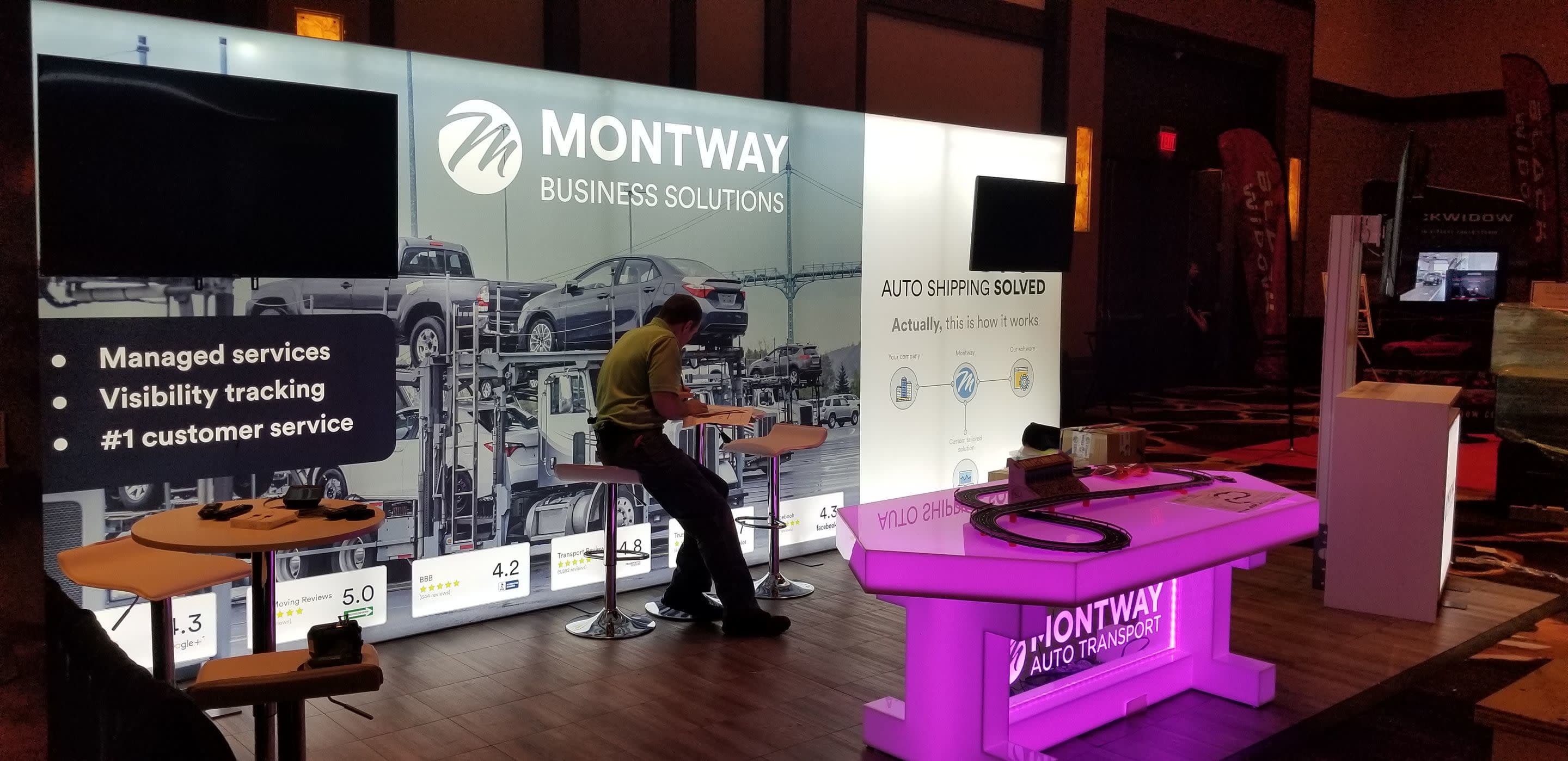 EBISS Inc: Exhibition booth with large illuminated backwall, mounted TV screens, counter & display assets