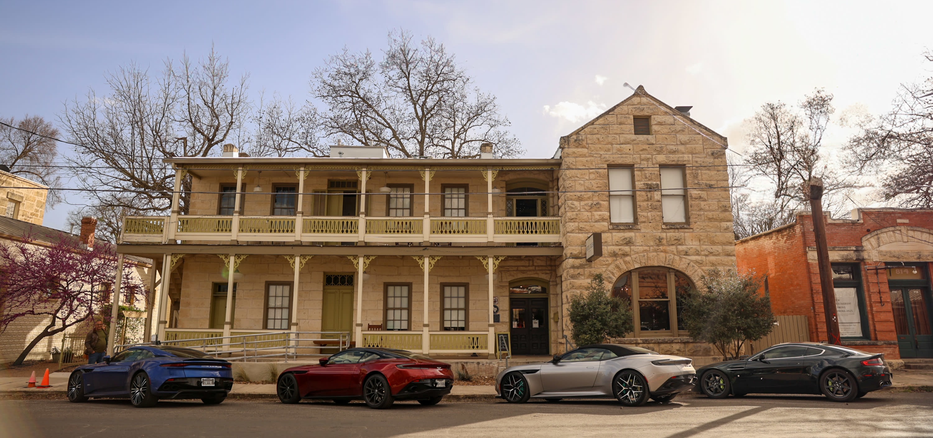 four Aston Martins parked in front of Hotel Giles