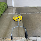 Surface cleaner removing dirt from concrete during a pressure washing service in Sacramento