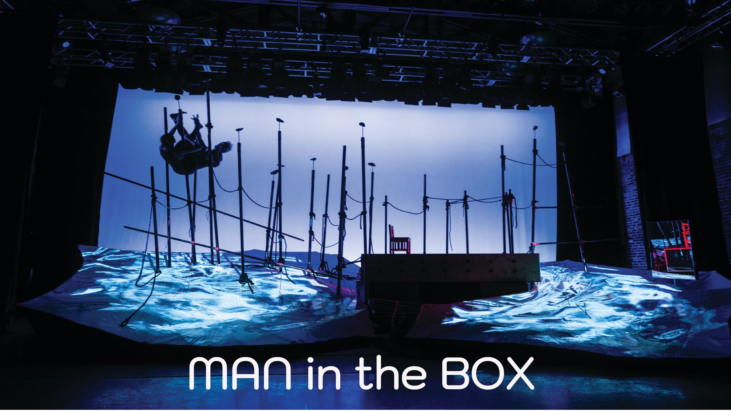 A stage with sculptural design features 19 that are 15 feet tall and have a diameter equal to a hand grip. The poles create a