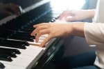 Close up image of hands playing the piano