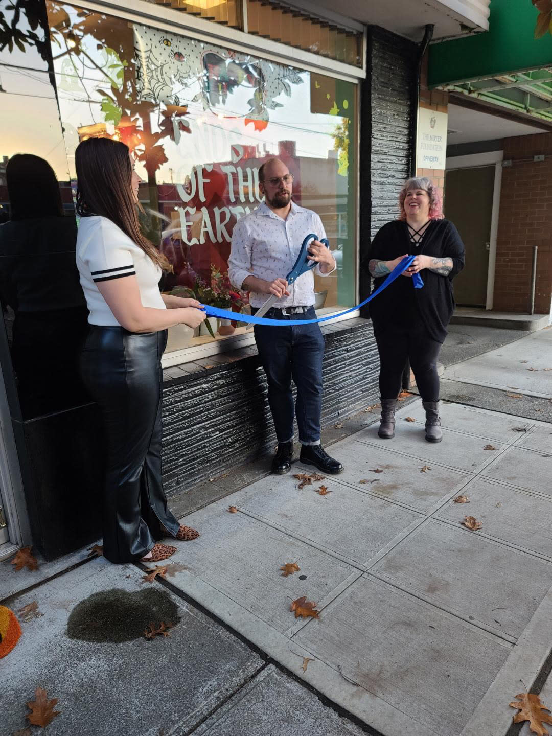 Nic holding the scossors for the Grand Opening while Lucia and Veronica hold the ribbon