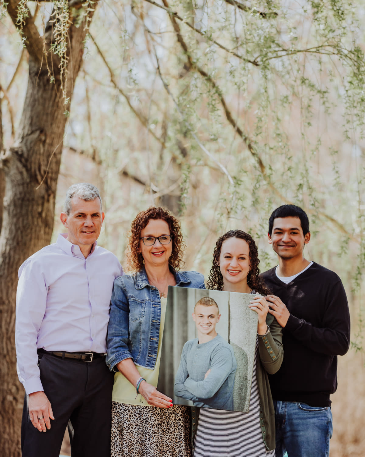 A family holds a memorial photo