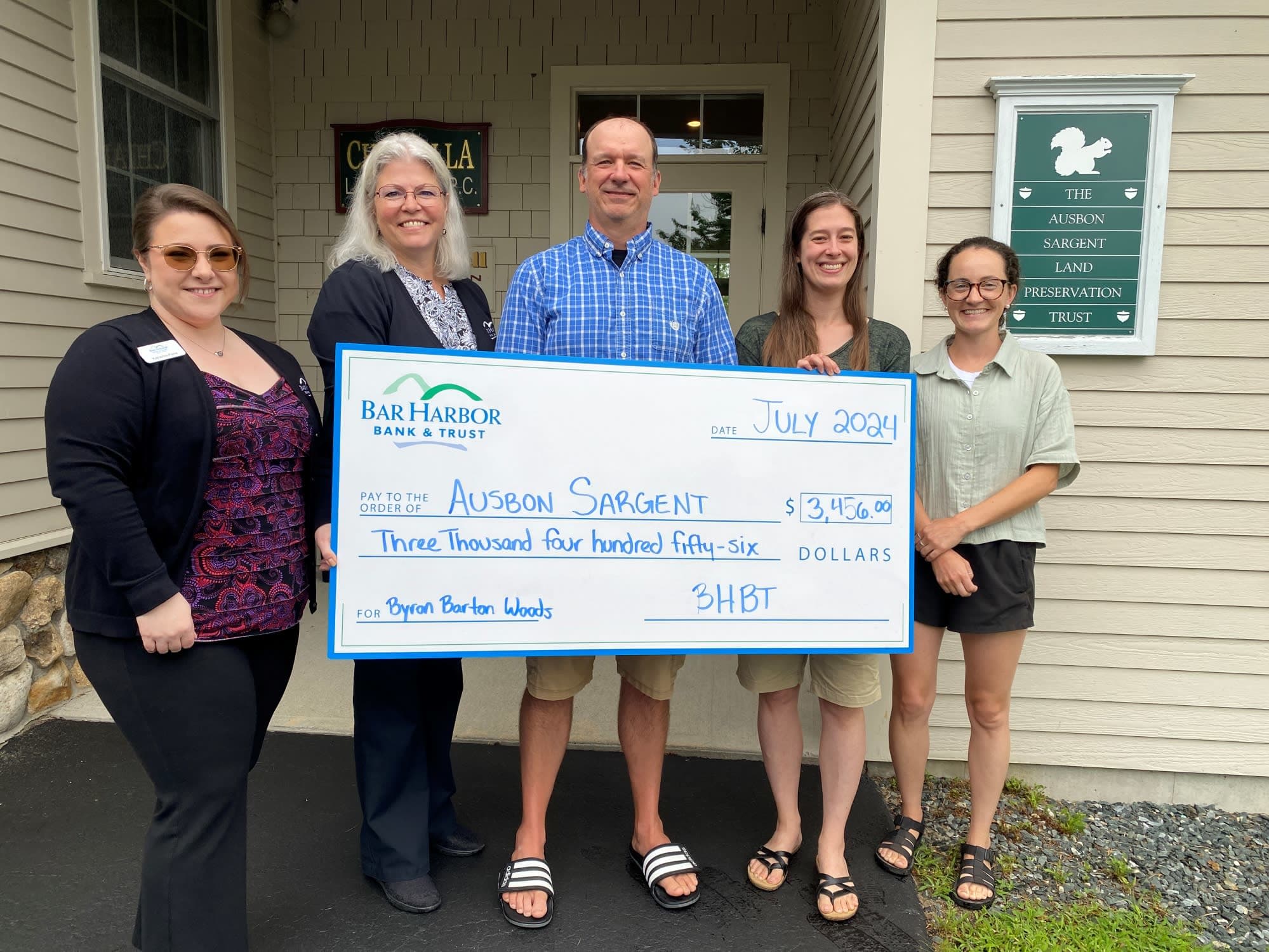 Bar Harbor Bank & Trust employees present a donation to Ausbon Sargent Land Preservation Trust.