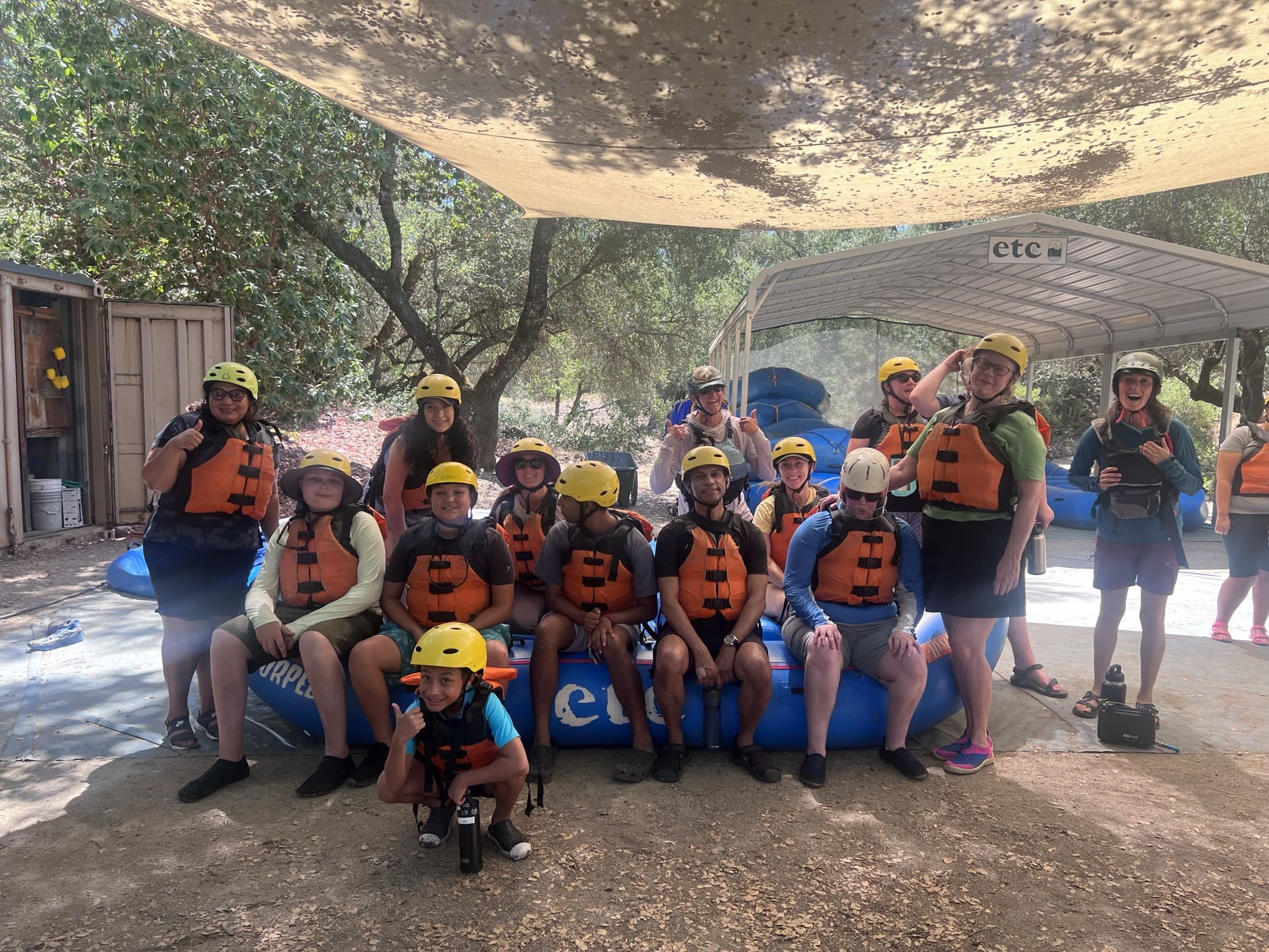 13 people sitting on a raft