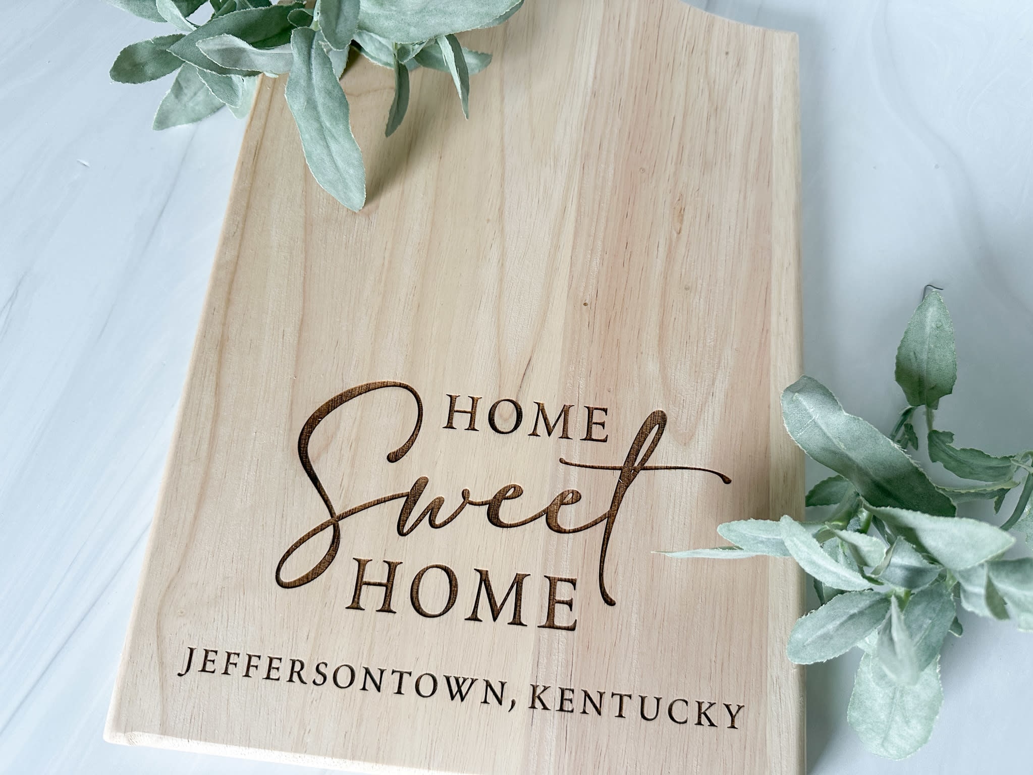 light oak cutting board with Home Sweet Home and Jeffersontown, Kentucky engraved onto it