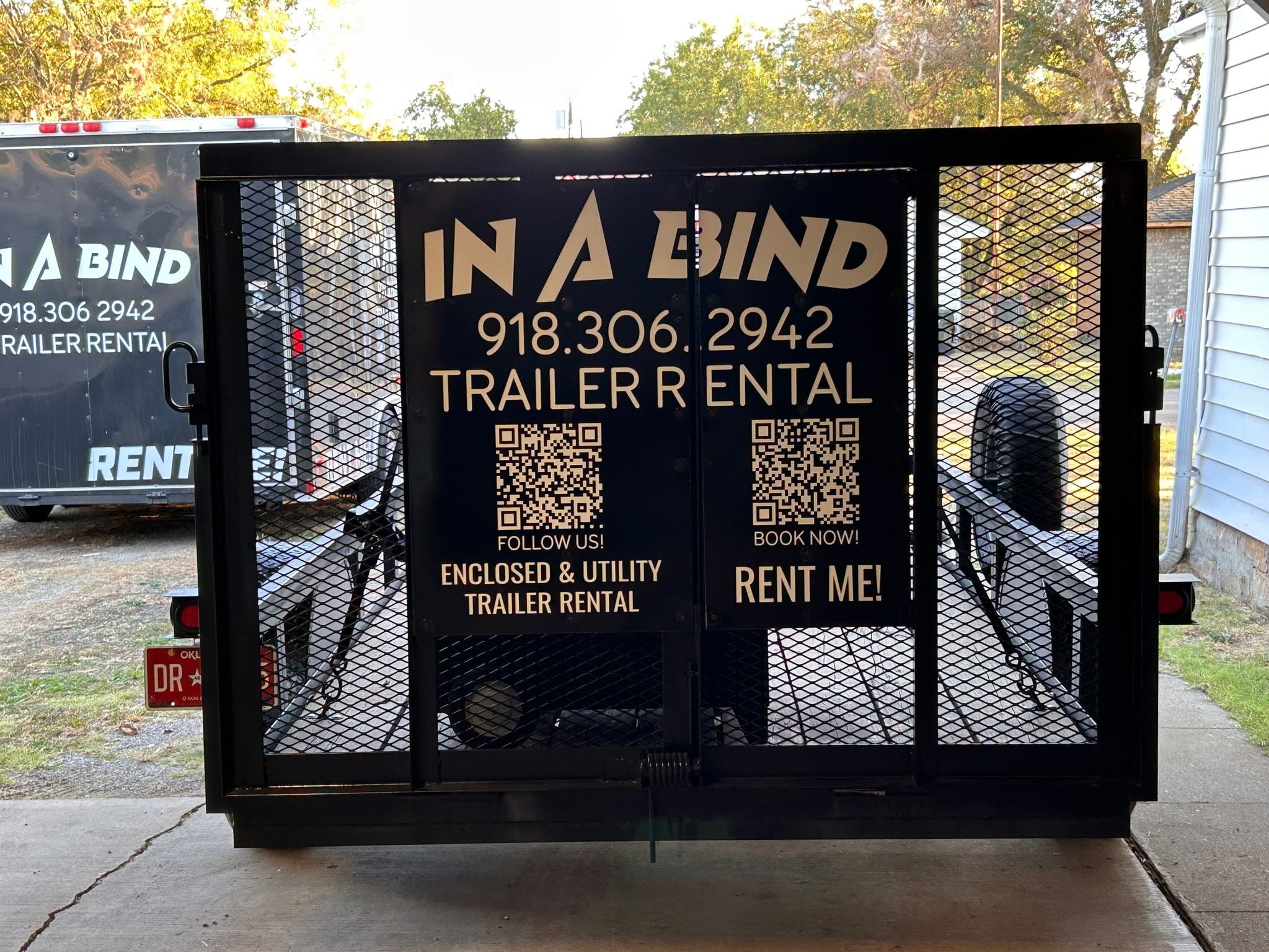 In A Bind Trailer Rental Logo on Back of Utility Trailer with contact info and QR Codes
