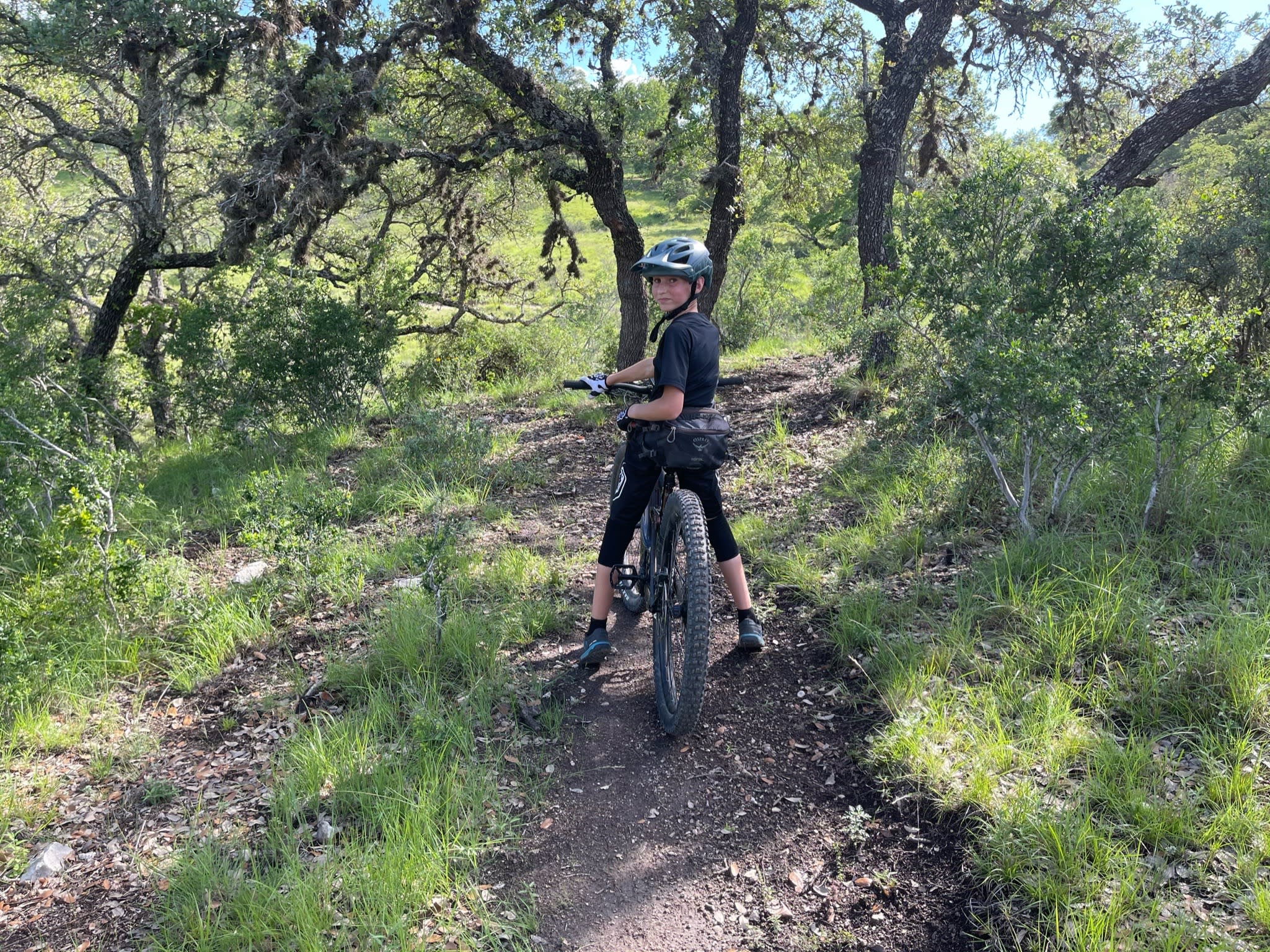 boy on bike in woods