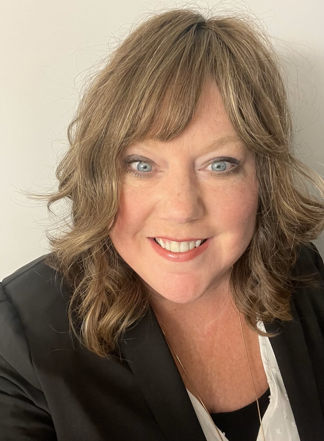 Jennifer Olson smiling wearing business attire