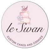 A beautifully decorated custom cake and matching cookies by Le Swan Custom Cakes & Cookies