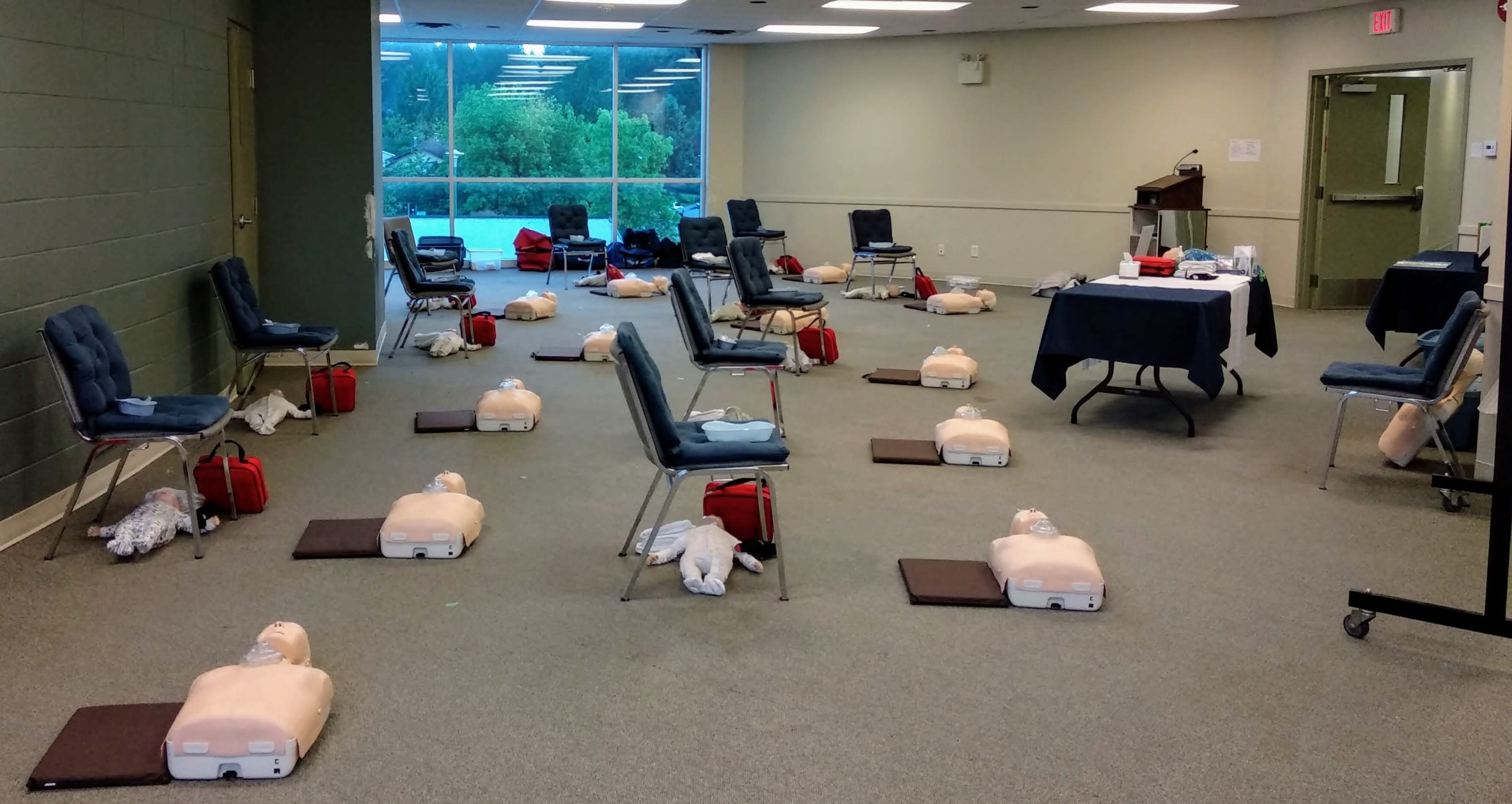 Safe + Sound First Aid Training classroom with first aid stations set up next to each person's chair.