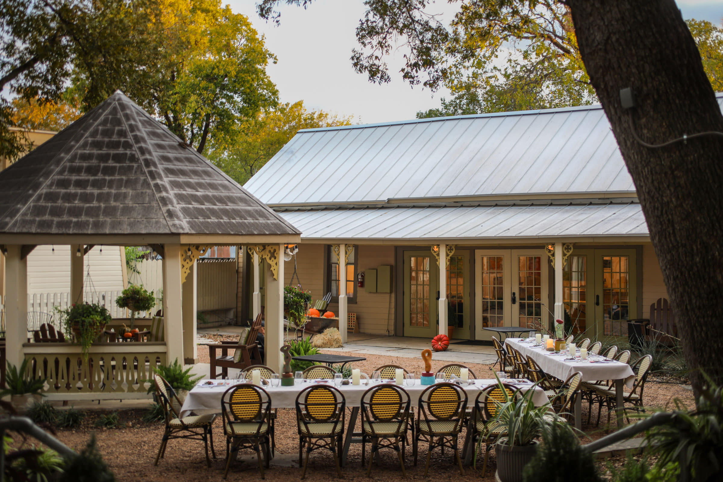 two long dinner tables and gazebo in courtyard