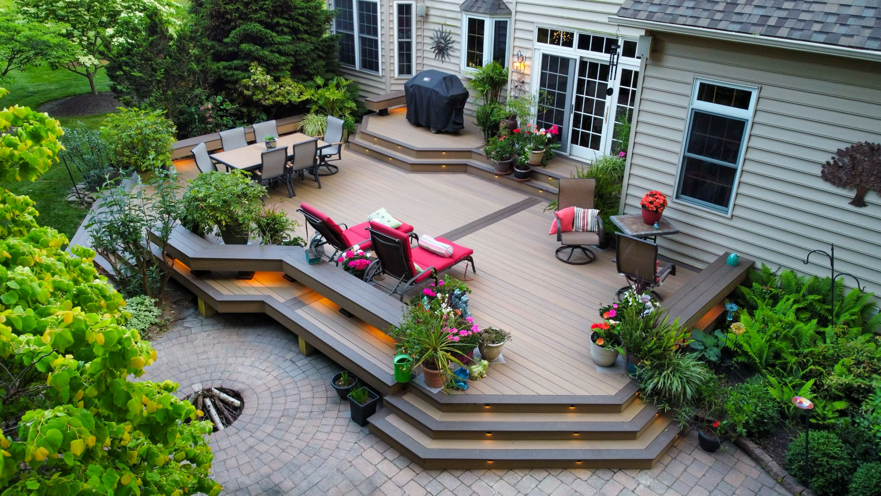 Outdoor living space with a multi-level deck and patio furniture