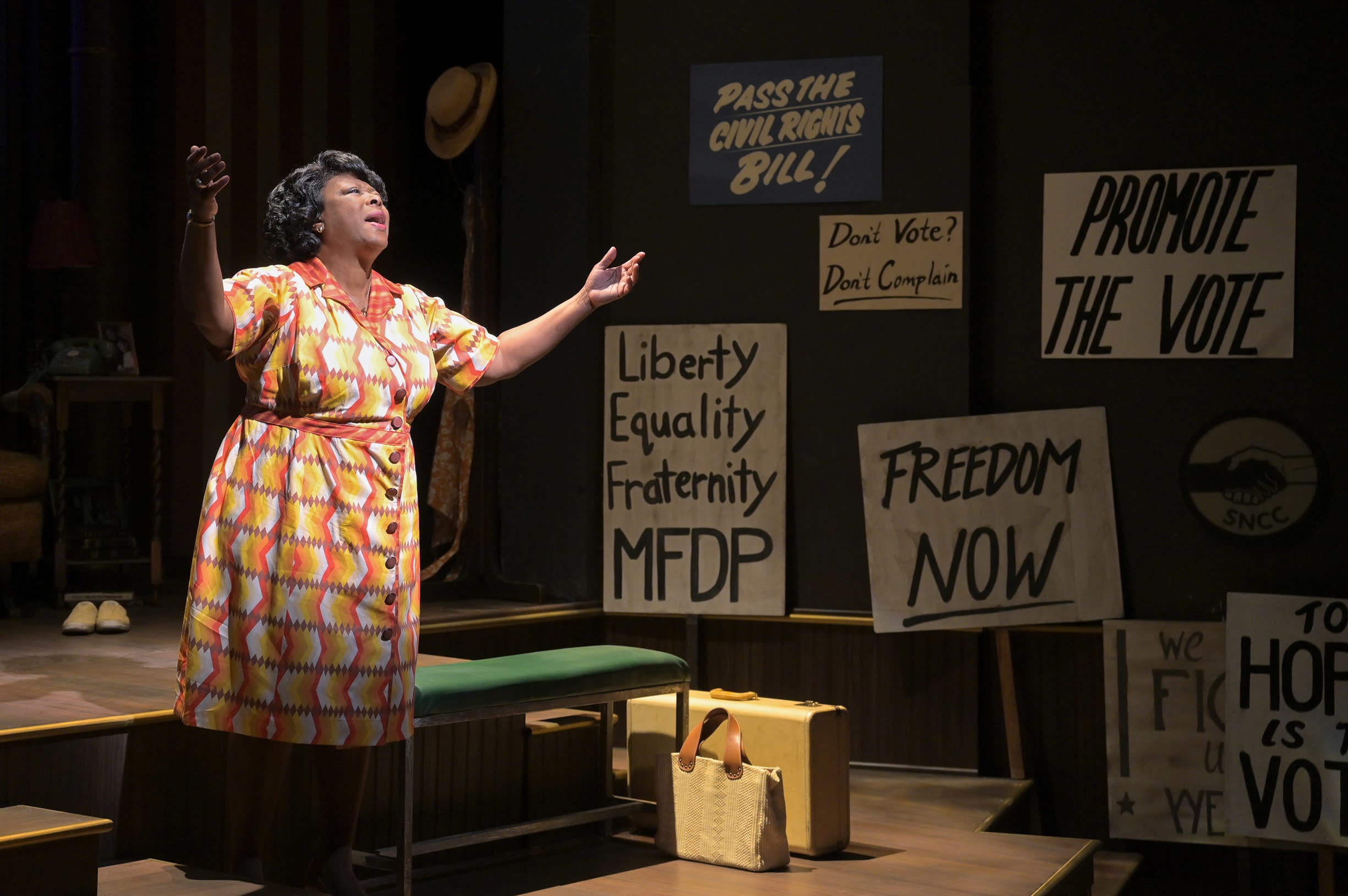 Greta Oglesby as civil rights activist Fannie Lou Hamer gestures to the sky while singing.