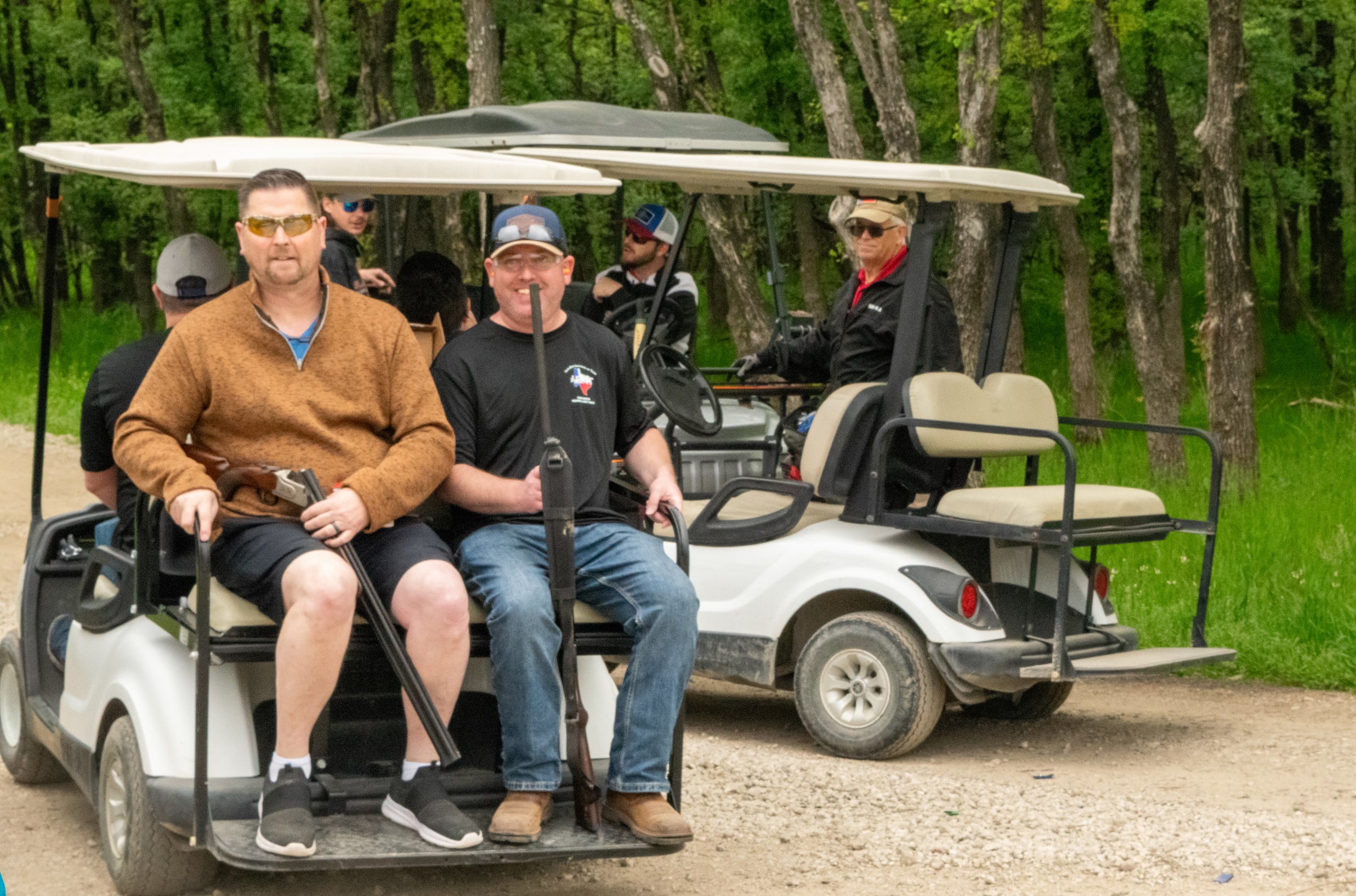 men riding on a golf cart