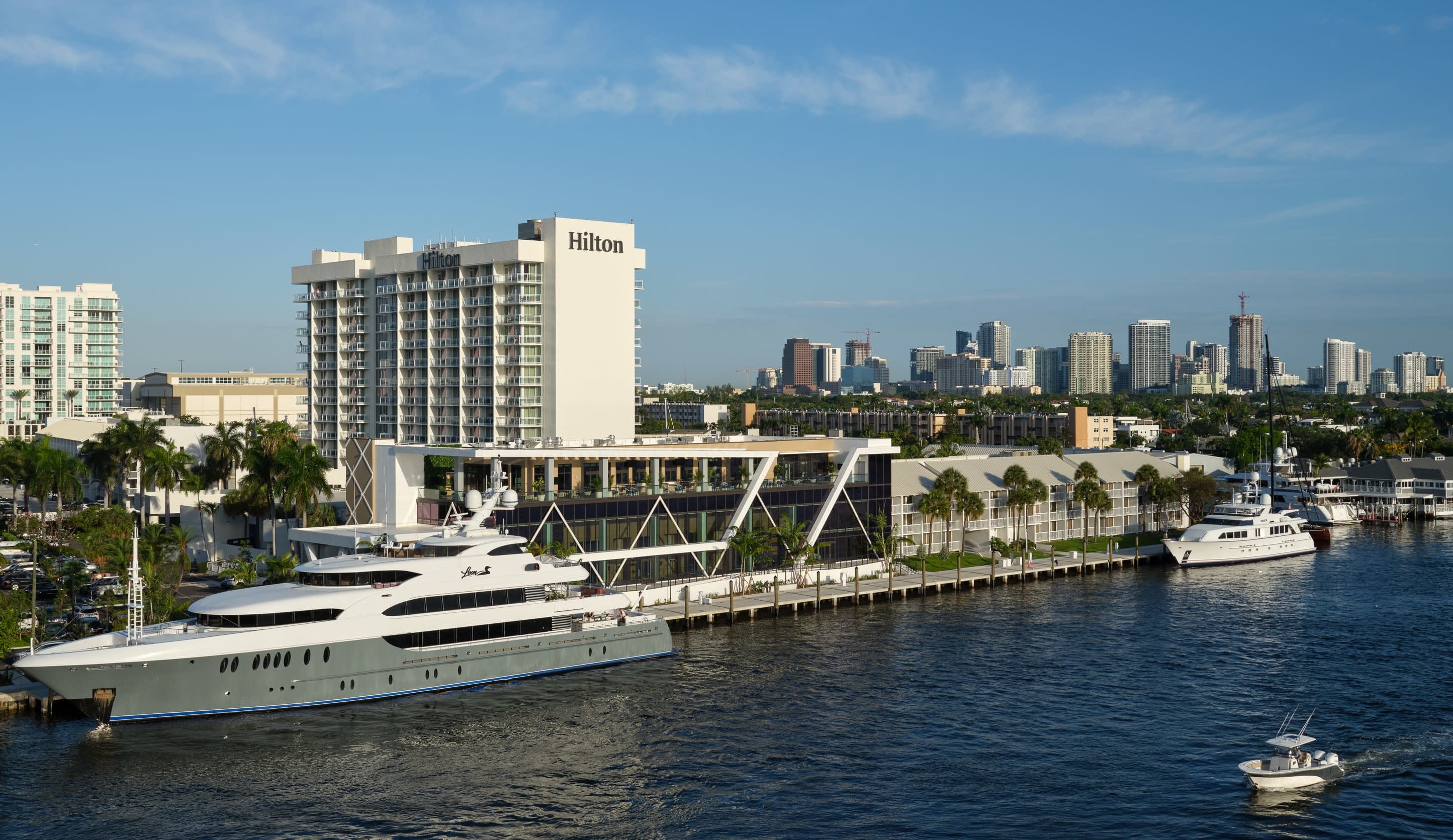 Hotel exterior on the water with downtown skyline in the background