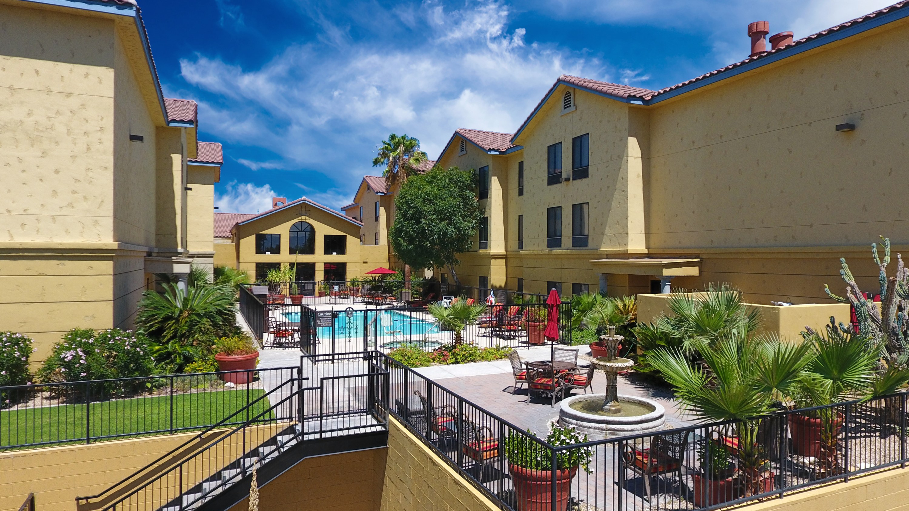 Outdoor pool and whirlpool at Hampton Inn & Suites Tucson Mall with lounge chairs.