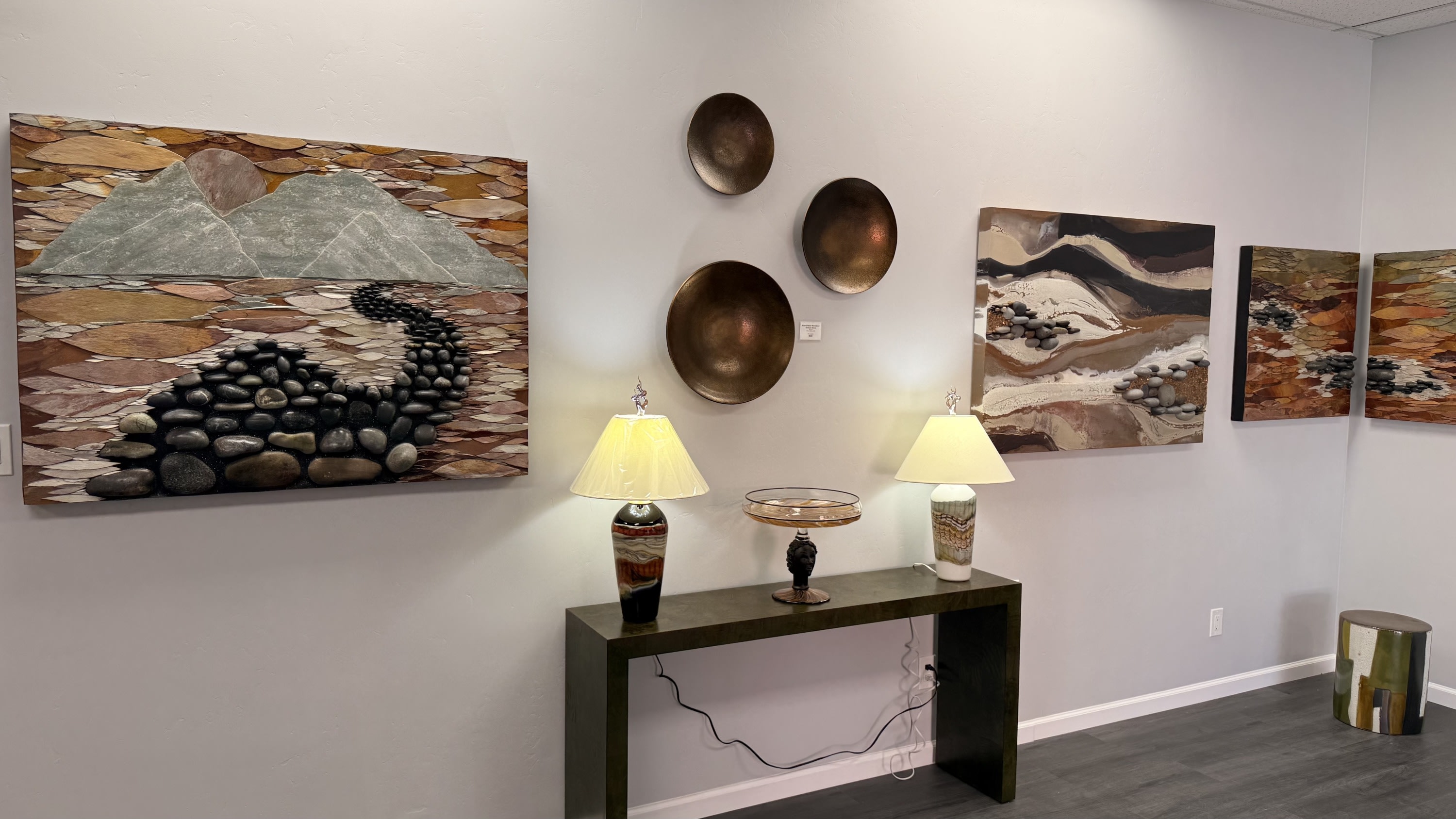 Earth tone dimensional wall art by Erika Bushee. Furniture by Revelation