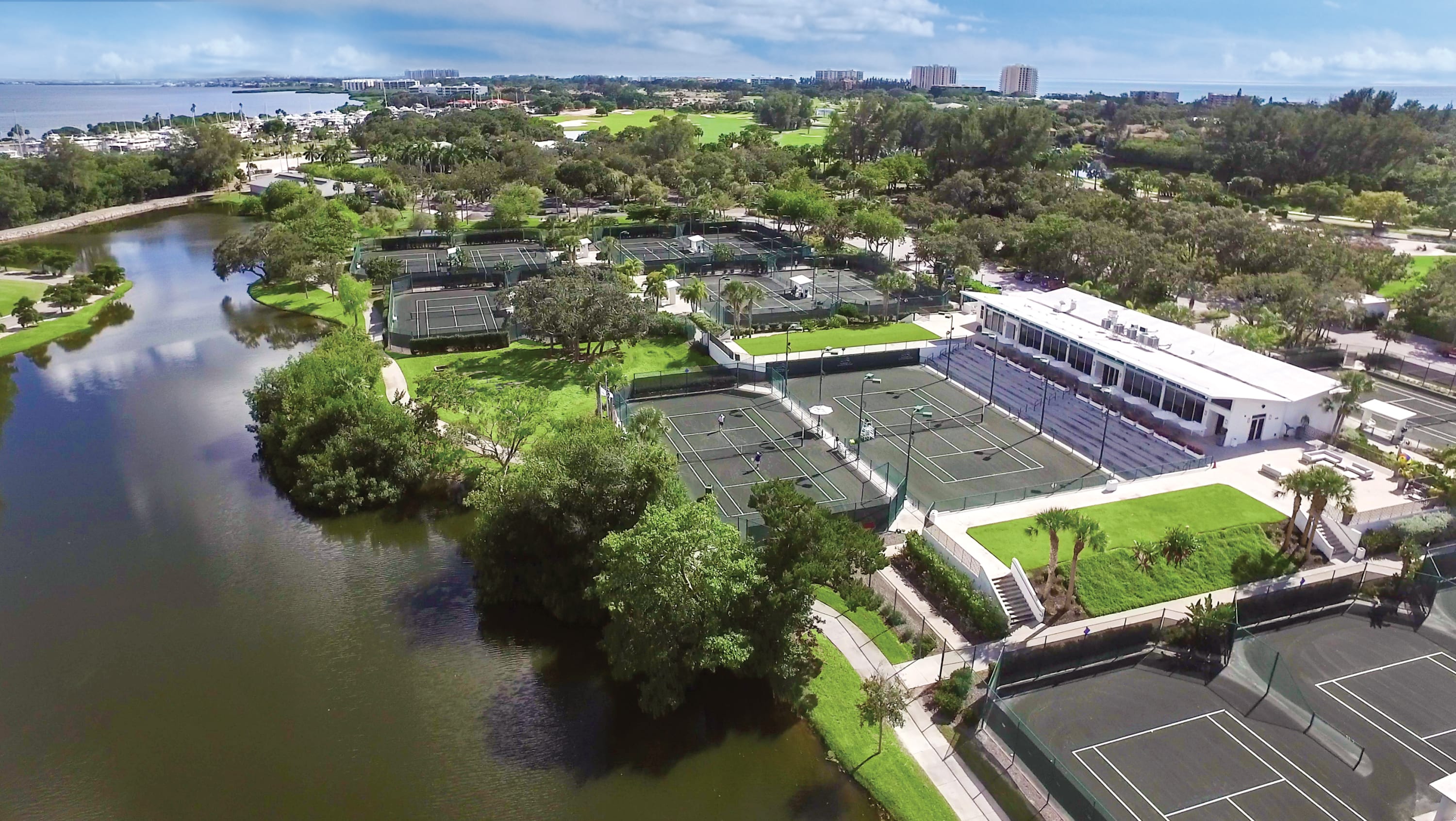 The Tennis Gardens tennis courts and building next to lagoon