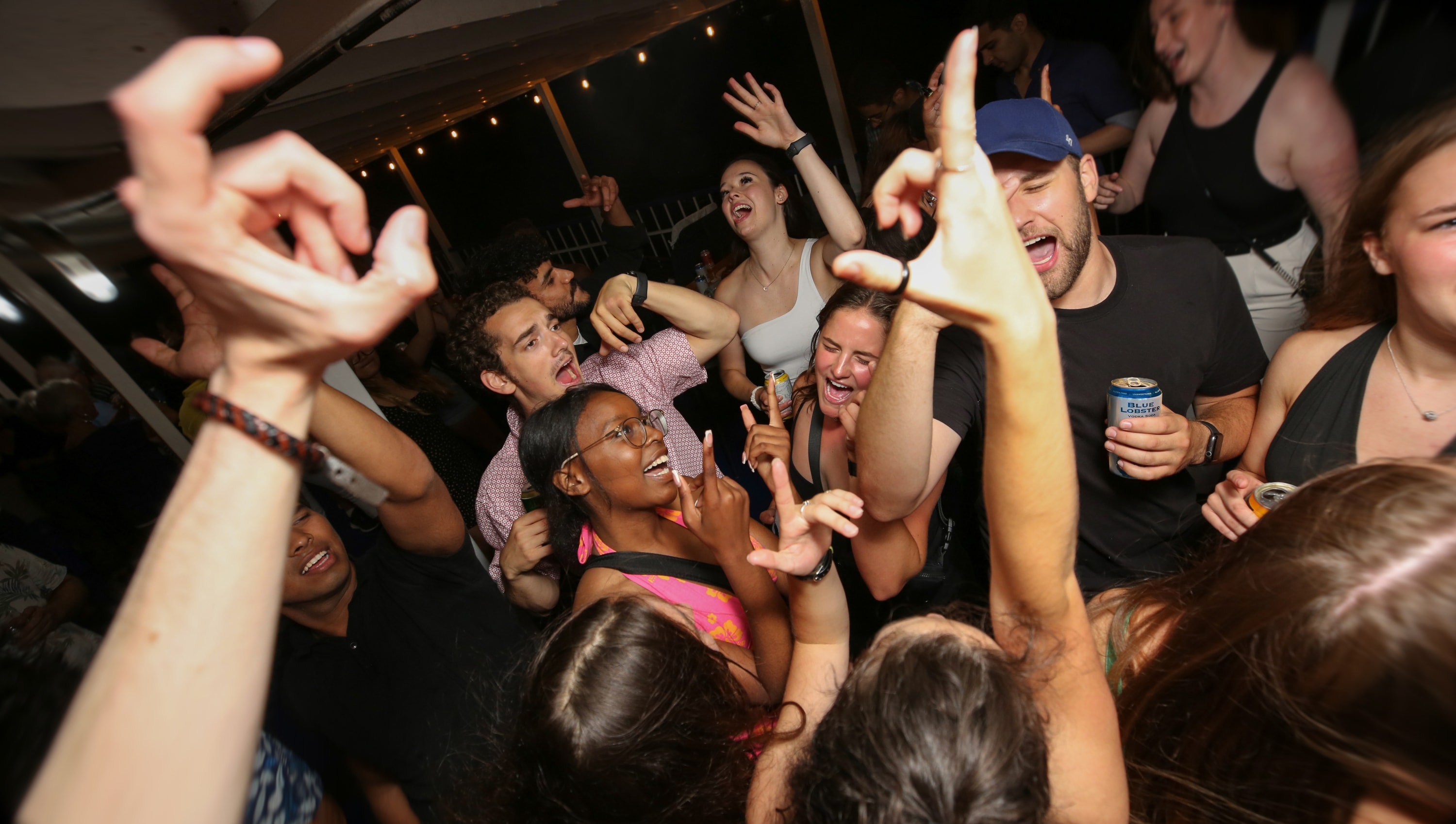 A group of friends party on the Blue Lobster Party Cruise aboard Harbour Queen