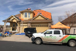 Cenco Roofing working a house with the truck parked in front